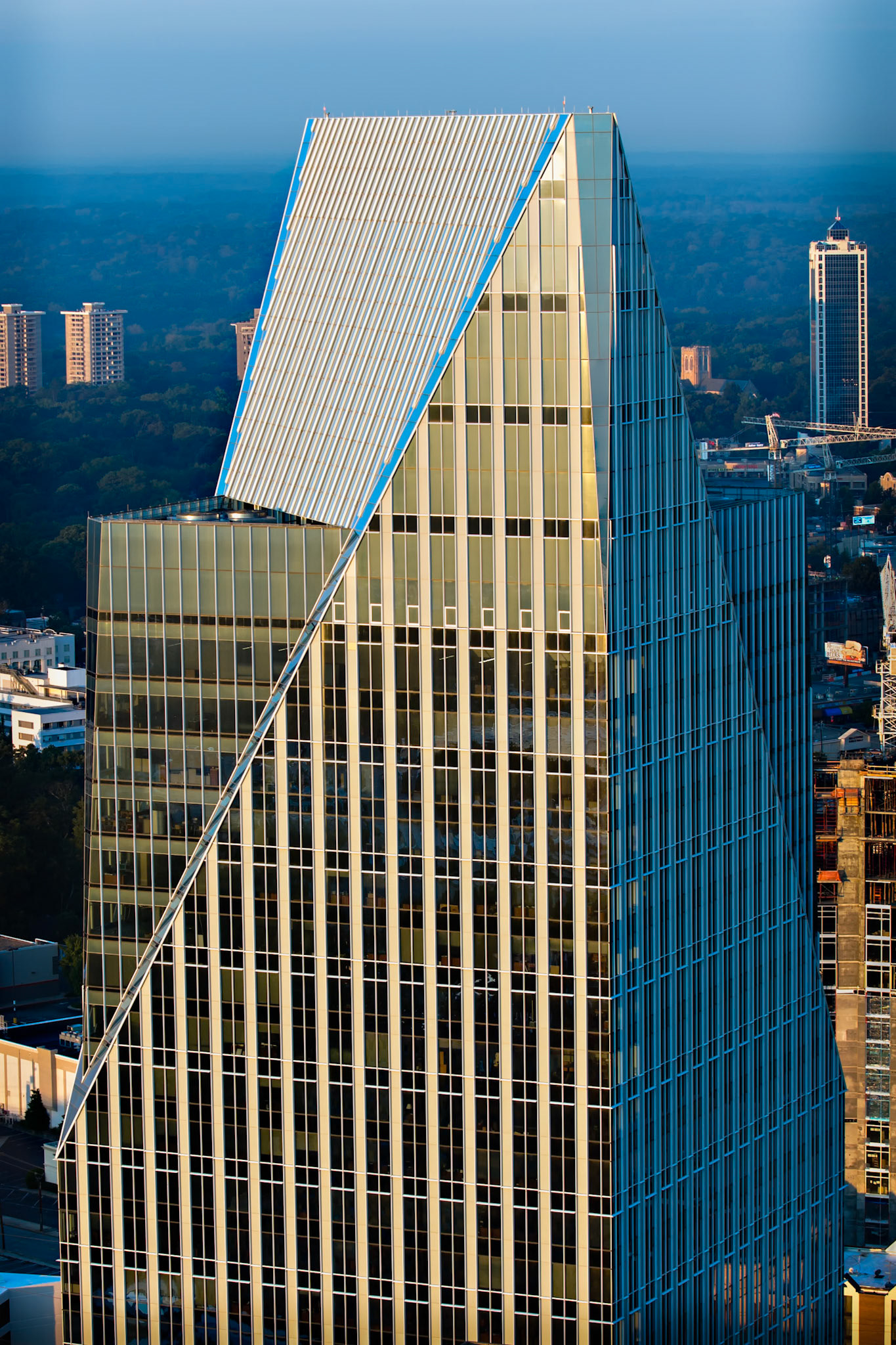 TERMINUS  |  Rising above Buckhead's skyline, Terminus is a reminder that great cities are always evolving. Its sharp angles and striking design stand apart from the traditional towers surrounding it, creating a modern architectural landmark that reflects Atlanta's ambition and energy.As a photographer, I am fascinated by the way light transforms glass and steel. In the late afternoon, the building's geometric lines catch the sun, turning an office tower into an abstract study of shape, reflection, and symmetry. From this perspective, the city falls away and the structure becomes the subject, its bold architecture commanding attention against the distant horizon.The name "Terminus" carries special meaning in Atlanta. It recalls the city's origins as the end of a railroad line, a place where journeys once concluded but new opportunities began. Today, that spirit of growth and reinvention remains woven into the city's identity.