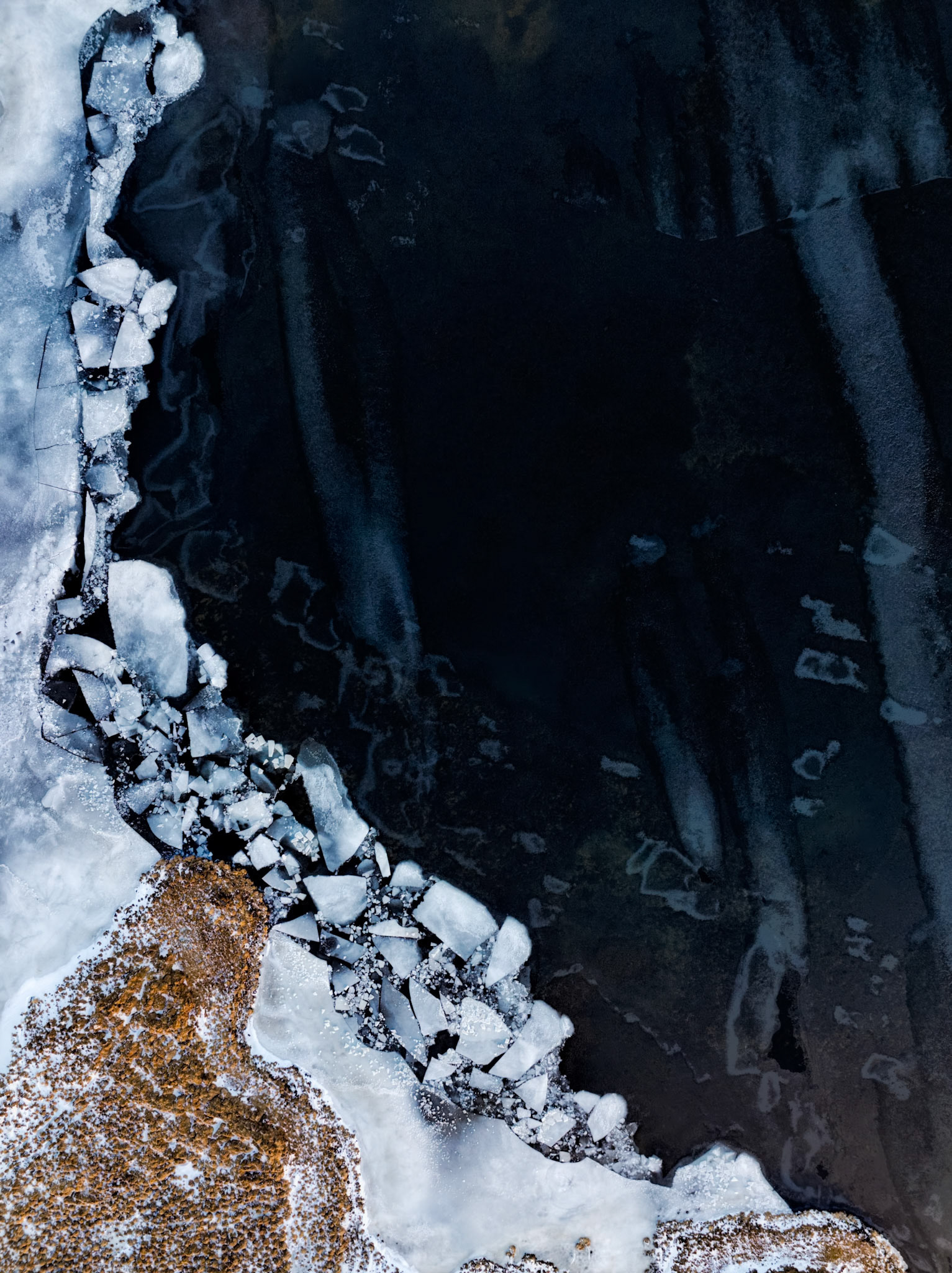 FROZEN BOUNDRY  |  From above, winter reveals patterns that are invisible from the ground. A dark ribbon of open water carves its way through a landscape locked in ice, creating a striking boundary between motion and stillness, life and dormancy.