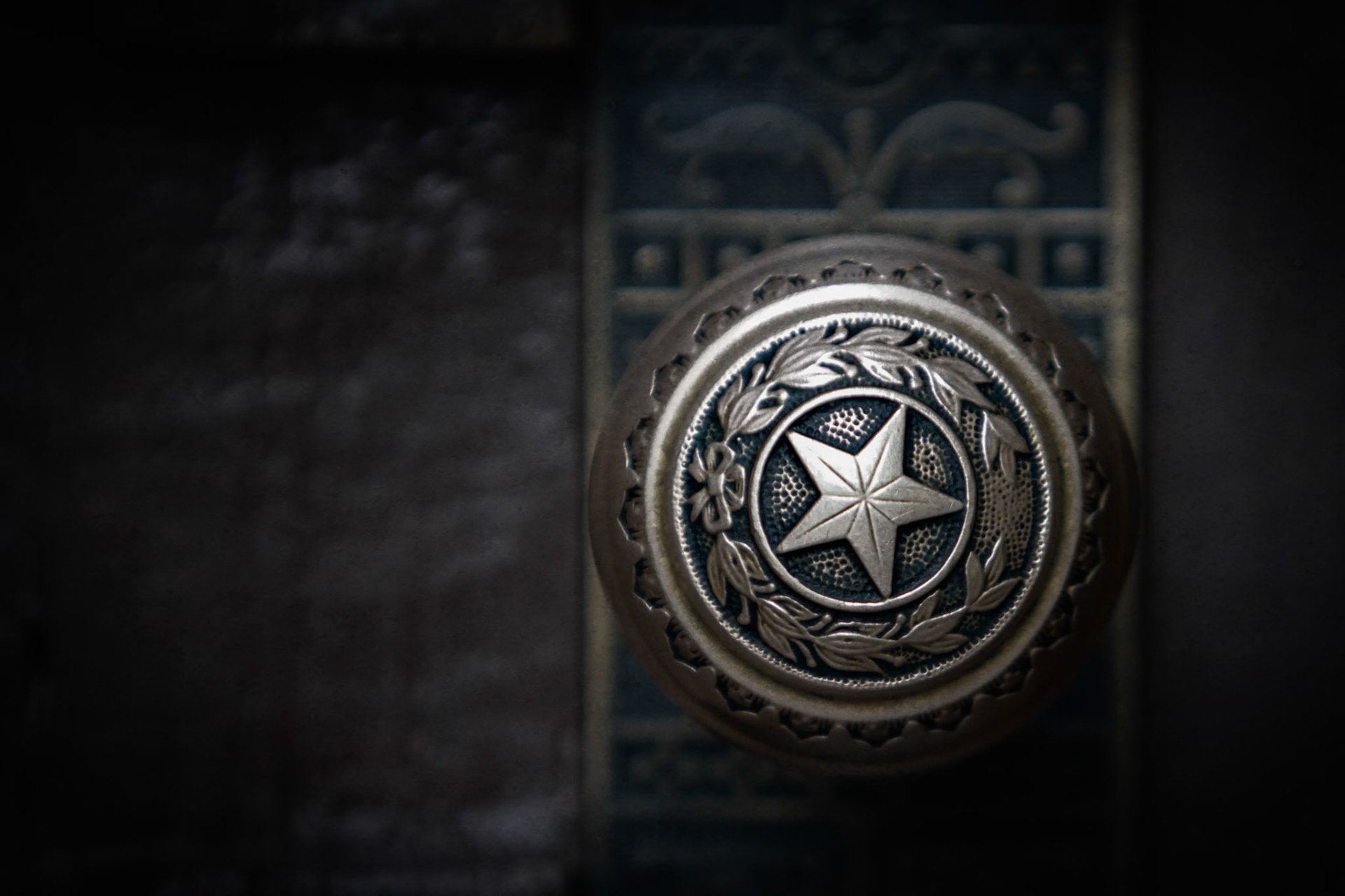 SEAL OF THE REPUBLIC  |  While most visitors look up at the Capitol's grand dome, I found myself drawn to a much smaller detail. This decorative doorknob, adorned with the Texas Lone Star, reflects the craftsmanship found throughout the building.The worn metal surface and intricate design hint at decades of use, while the shallow depth of field isolates the emblem from its surroundings. What could easily be overlooked becomes a small but meaningful symbol of Texas identity.