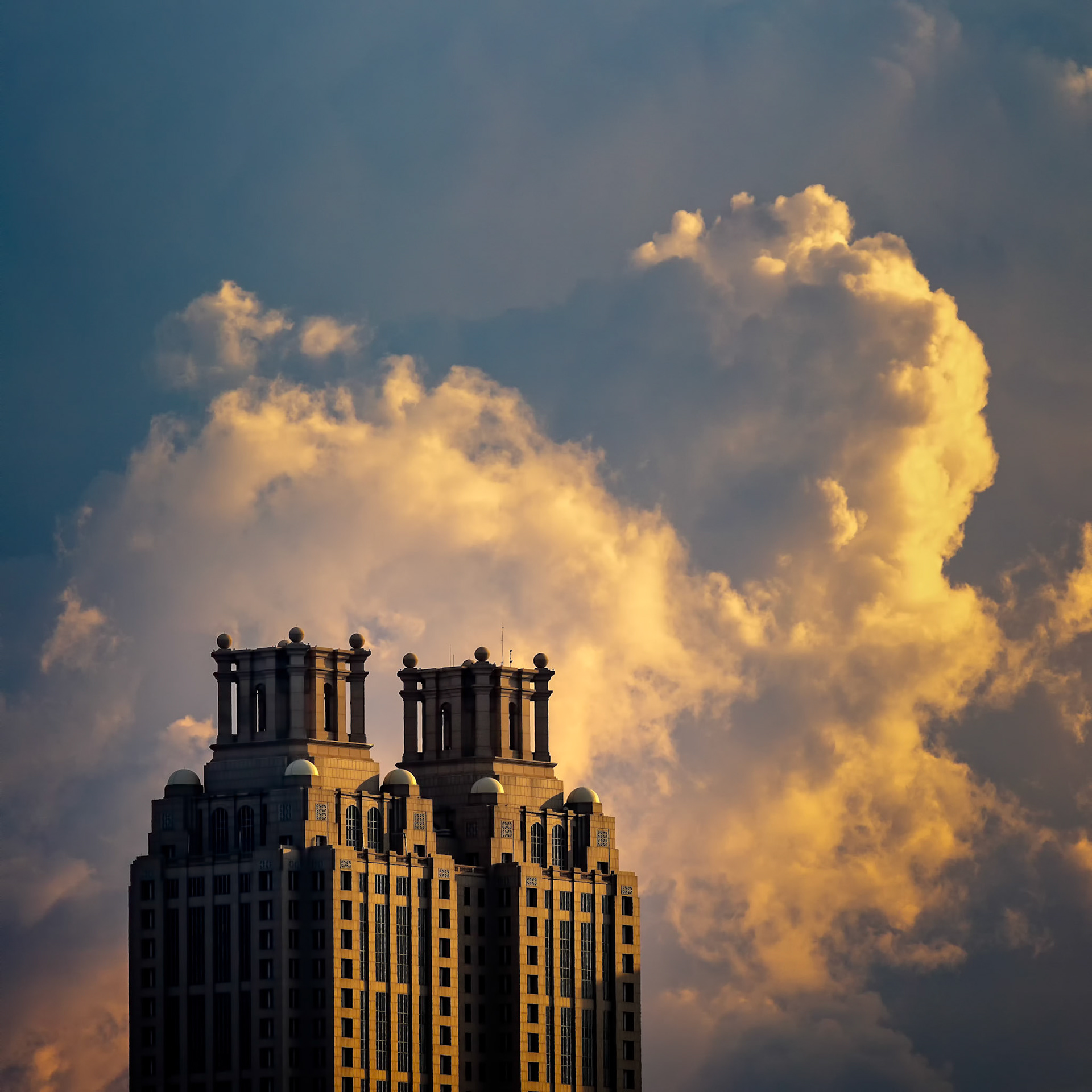 FORM AND SKY  |  Rising above Midtown Atlanta, the twin crowns of 191 Peachtree stand in quiet contrast to the drama unfolding behind them. Towering clouds, illuminated by the setting sun, transform the skyline into a fleeting spectacle of light and shadow.For a brief moment, architecture and atmosphere share the stage, creating a scene that feels both powerful and serene.