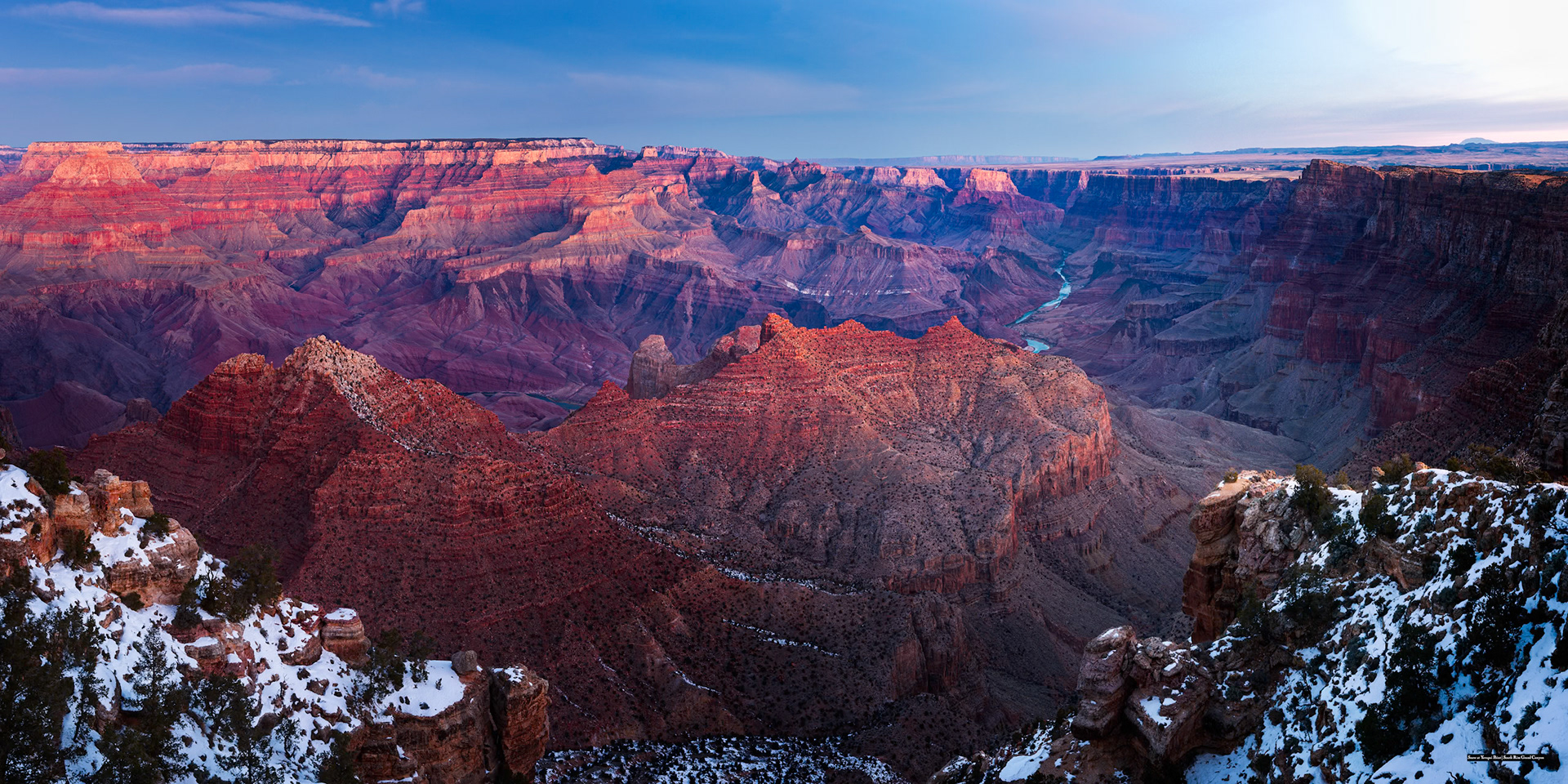 WINTER ON THE RIM  |  The Grand Canyon is breathtaking in every season, but winter reveals a side that few people expect.On this frigid morning, the temperature hovered well below freezing as the first light of day crept across the canyon walls. Snow clung to the rim and shaded ledges, creating a striking contrast against the warm reds, purples, and ochres that have made this landscape famous. The Colorado River, barely visible in the distance, wound its way through nearly two billion years of Earth's history.What struck me most was the scale. Standing at the edge, the canyon seemed less like a geological feature and more like an entire world unto itself. Layer upon layer of rock stretched toward the horizon, each revealing a chapter in a story far older than humanity. The winter snow added a sense of quietness, softening the landscape without diminishing its immense power.In moments like this, it becomes impossible not to feel humbled. The cold air, the vast silence, and the sheer magnitude of the canyon create a rare awareness of both our smallness and our connection to something much larger.