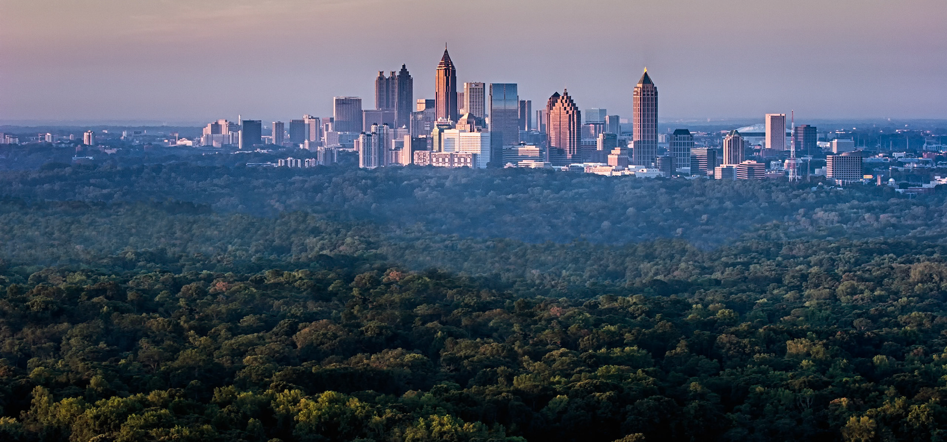 ATLANTA SKYLINE  |  From the top of the Sovereign in Buckhead, Atlanta reveals a side of itself that surprises many first time visitors. Beyond the skyline lies an endless canopy of trees, stretching mile after mile toward the horizon. Here, the city doesn't replace nature. It rises from it.As the evening light softened across downtown, the towers glowed above a sea of green, creating a scene that felt more like a national park with skyscrapers than a major metropolitan area. The contrast is what makes Atlanta unique. Modern architecture and urban energy coexist with one of the largest urban forests in America.For a photographer, this view captures the essence of the city: ambitious, vibrant, and unexpectedly connected to the natural landscape that surrounds it.