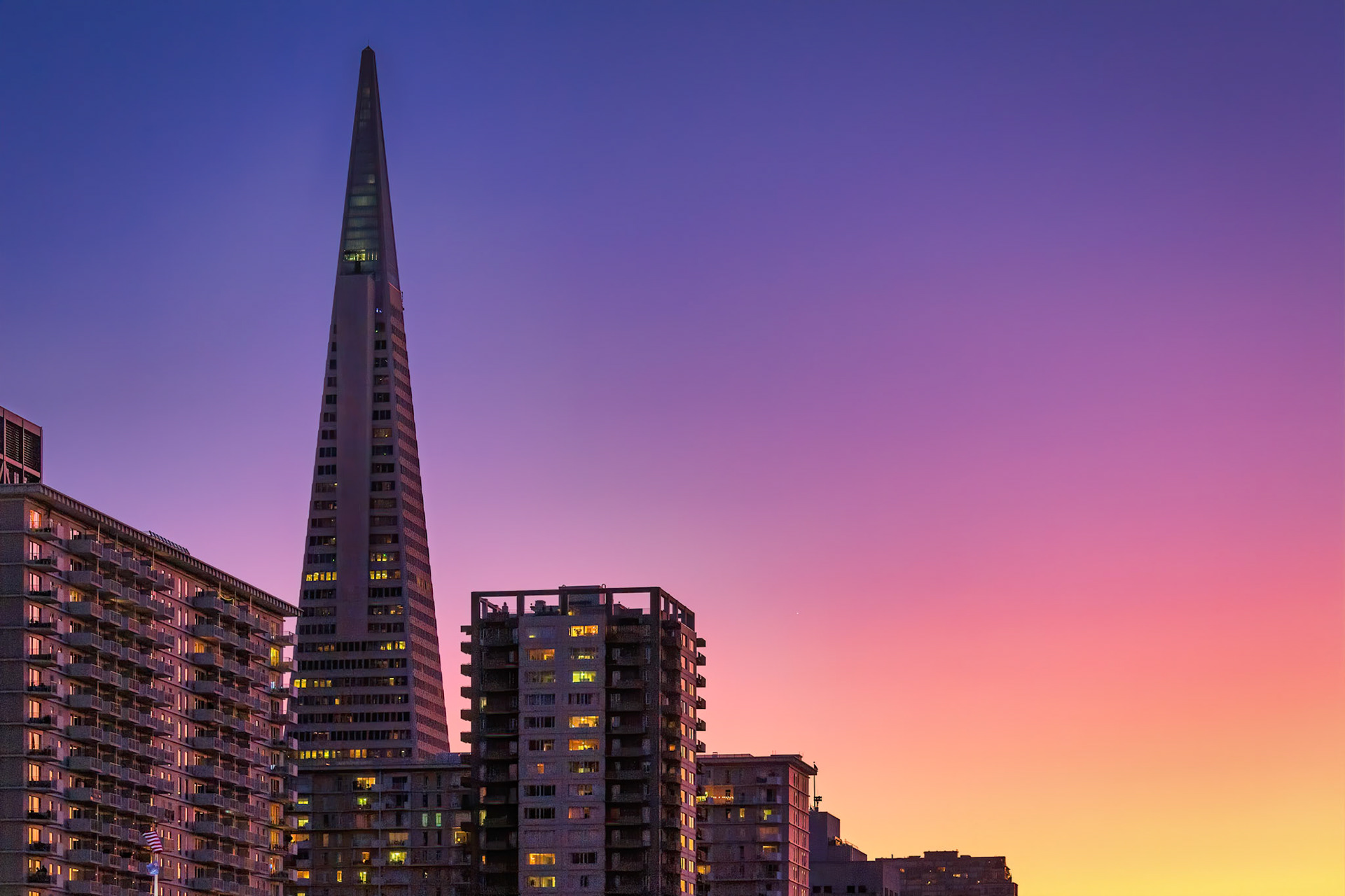 PACIFIC TWILIGHT  |  Few buildings are as instantly recognizable as San Francisco's Transamerica Pyramid. For decades, it has stood as a symbol of the city, rising above the skyline with a form that is both simple and unmistakable.What captivated me on this evening was not just the building itself, but the extraordinary color unfolding around it. As the last light of day faded, the sky transitioned through layers of gold, rose, lavender, and deep blue, creating a backdrop that seemed almost painted. The Pyramid stood quietly within that color, no longer dominating the skyline but becoming part of the larger composition.The illuminated windows scattered throughout the scene hint at thousands of individual lives winding down their day while the city slips from daylight into evening. There is an unexpected calm here, a softness that contrasts with the energy usually associated with San Francisco.Photographers often chase dramatic weather, but sometimes the most memorable moments arrive on an ordinary evening when light, color, and timing align perfectly. For a few fleeting minutes, the city seemed suspended between day and night, wrapped in a palette that would vanish as quickly as it appeared.