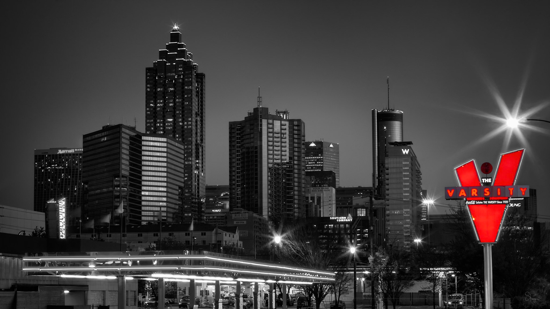 AN ATLANTA ICON  |  For generations of Atlantans, this sign has been more than a landmark. It is a symbol of the city itself. Standing proudly against the downtown skyline, the iconic Varsity "V" has welcomed students, families, visitors, and late night diners for nearly a century.What attracted me to this scene was the contrast between old and new. Atlanta's modern skyline rises in the background, constantly evolving and reaching higher, while the glowing red Varsity sign remains unchanged, a familiar beacon amid the city's transformation. The selective color treatment reinforces that relationship, allowing the sign to command attention while the city quietly supports the story behind it.As a Georgia Tech neighbor and Atlanta institution, The Varsity has become woven into the fabric of countless memories. First dates, football weekends, family traditions, and late night meals all seem to converge beneath that unmistakable red "V."