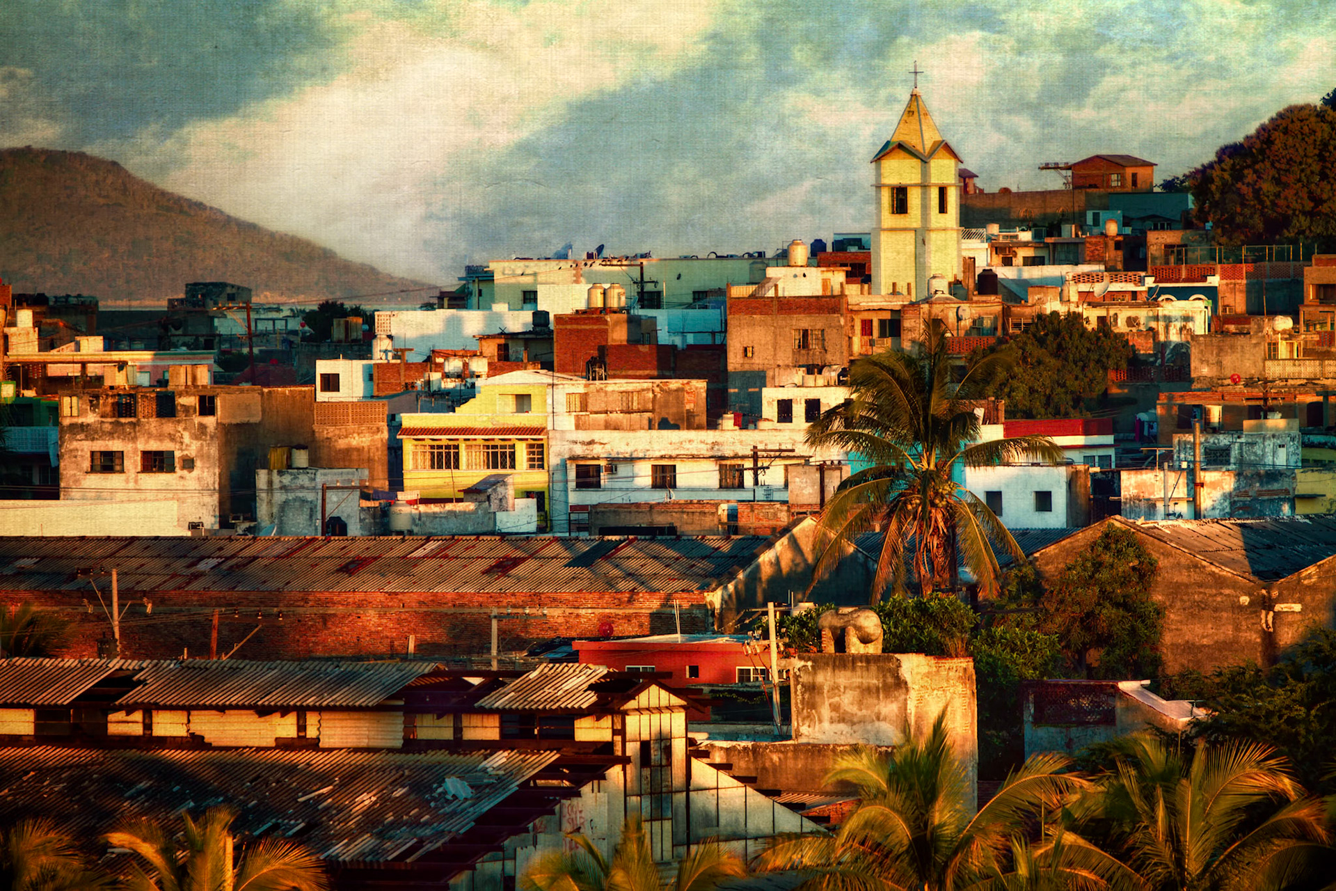 SUNRISE IN MAZATLAN | MEXICO  |  I made this photograph as the first light of day spilled across Mazatlán, transforming an ordinary neighborhood into a patchwork of color and texture. From my vantage point, the city was just beginning to wake up. Rooftops, palm trees, and the church steeple caught the warm morning light while much of the city remained quiet and still.What I remember most is how different the scene felt from the beachside image many visitors associate with Mazatlán. This was everyday life, bathed in the same beautiful sunrise. Standing there, I was reminded that some of the most memorable travel experiences come not from famous landmarks, but from simple moments that reveal the character of a place and the people who call it home.