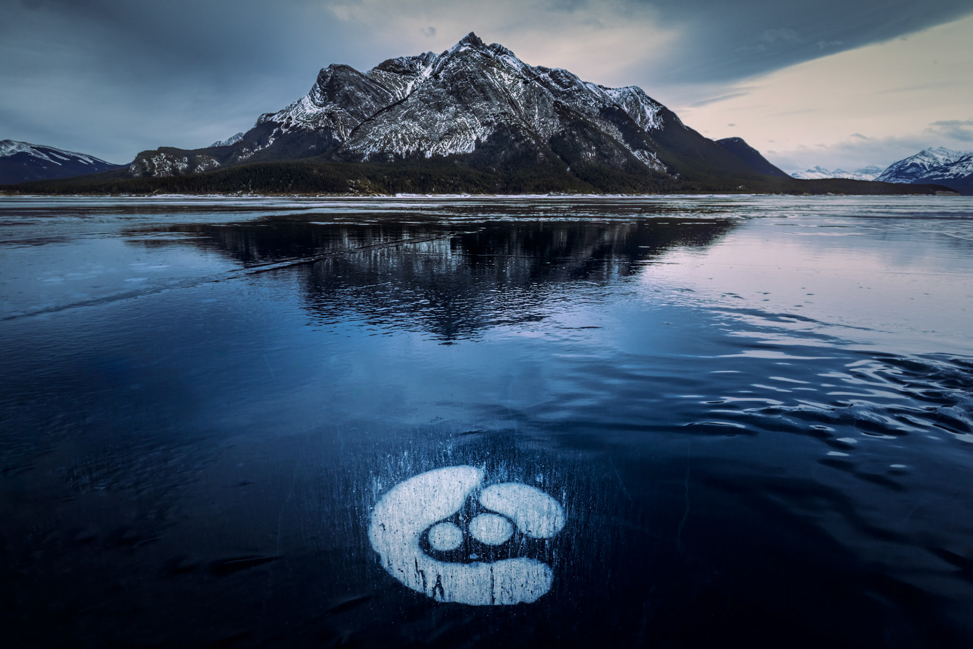 TRAPPED BREATH  |  Part of the magic of Abraham Lake lies in the discoveries that appear beneath your feet. While many visitors focus on the sweeping mountain views, I often found myself looking down, searching the ice for unusual patterns created by trapped methane bubbles.
