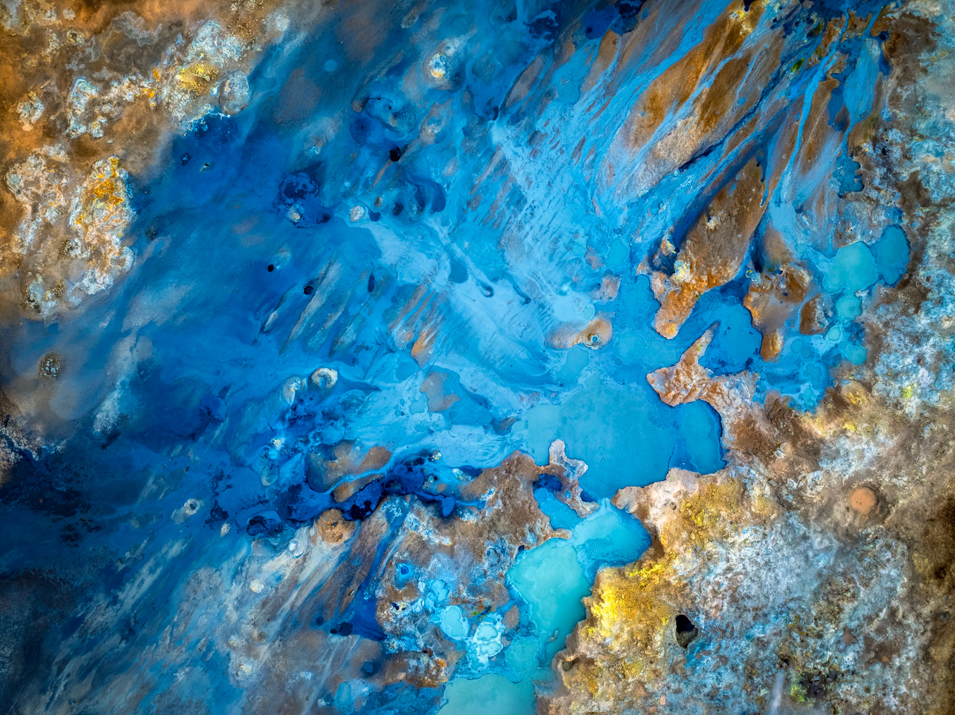 WHERE COLOR BECOMES LAND III  |  Iceland constantly reveals landscapes that challenge your perception of what the Earth should look like. Near Lake Mývatn, geothermal activity transforms the terrain into a palette of vivid blues, golds, whites, and grays, shaped by heat, minerals, and volcanic forces beneath the surface.