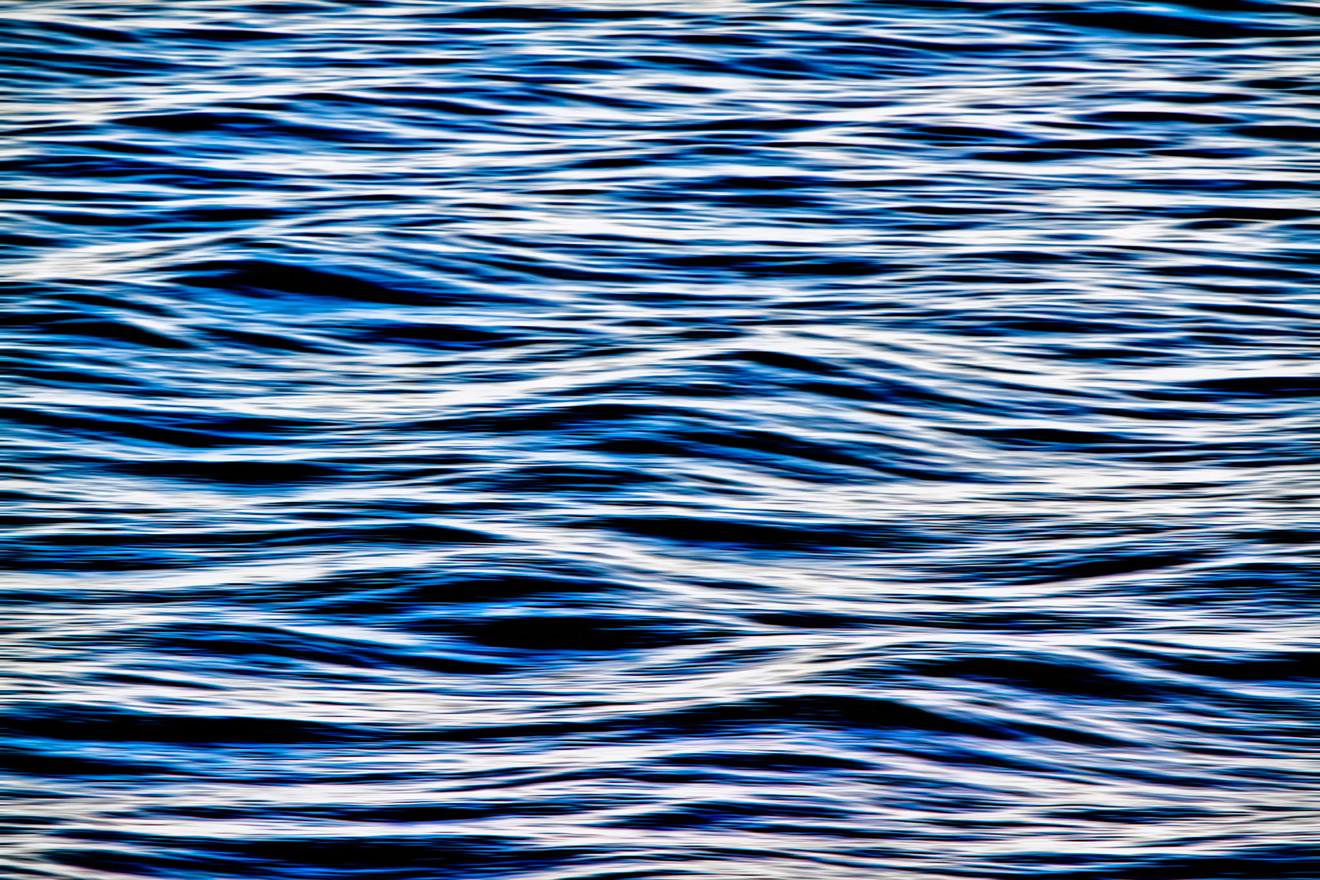 LIQUID MOTION  |  I made this photograph from the deck of a ship, watching the ocean slip by for hours. Most people were focused on the horizon, but I found myself fascinated by the patterns below. For a brief moment, the light, movement, and angle came together, turning the water into something that felt more like a painting than the sea.What I like most about this image is its simplicity. There is no shoreline, no boat, no sense of scale, just the rhythm of water in constant motion. It reminds me that even in the vastness of the ocean, beauty can be found in the smallest details.