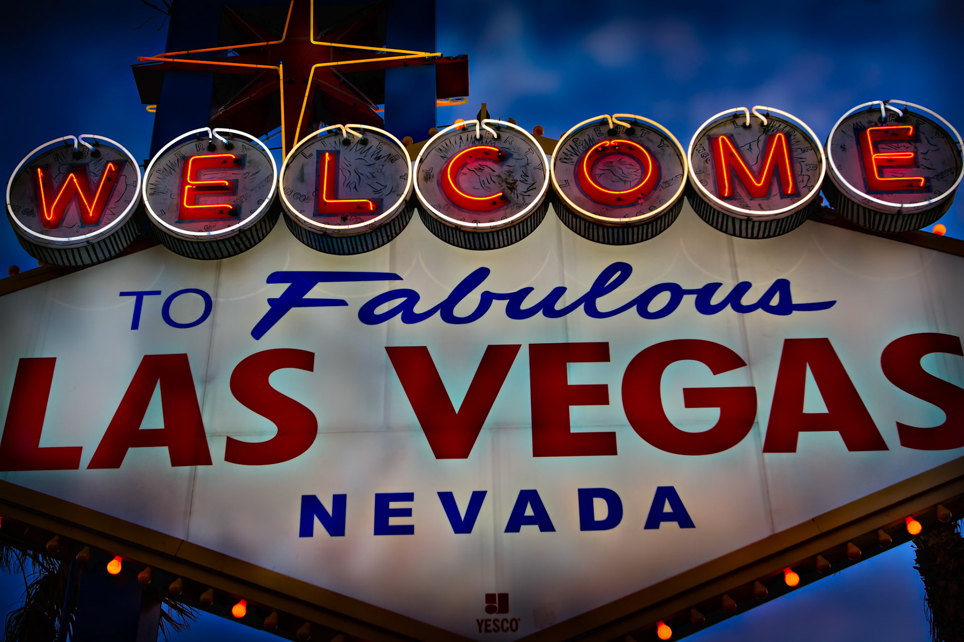 ...STAYS IN VEGAS  |  Most people photograph this sign from a distance, but I was more interested in the details. Up close, the glowing neon, weathered surfaces, and decades of signatures scratched into the circles reveal a history that often goes unnoticed.Standing beneath it at dusk, I realized this sign has welcomed millions of visitors since 1959. Long before the mega resorts and towering casinos, it was already announcing arrivals, departures, celebrations, and second chances. Every mark on its surface feels like a small piece of that story.To me, this photograph is less about a famous landmark and more about the passage of time. The lights still glow, the message remains the same, and people continue arriving with the hope that something memorable awaits just beyond the sign.
