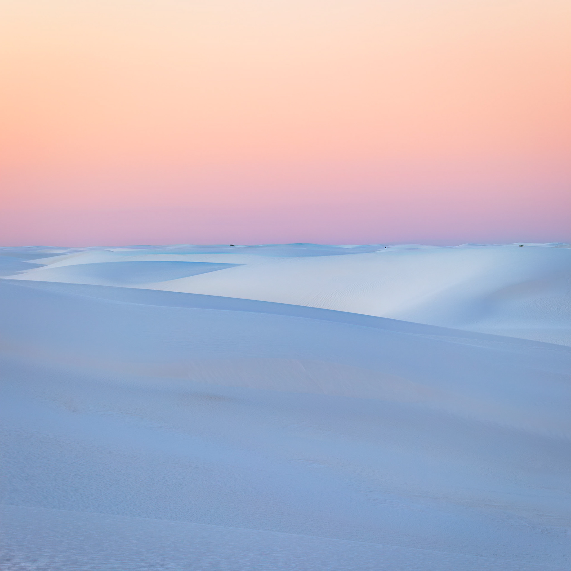 PASTEL HORIZON  |  The first light of day washes across the dunes of White Sands, transforming the landscape into a study of color, shape, and silence. Soft hues of peach, rose, and lavender drift across the sky while gentle blue shadows trace the contours of the pristine gypsum dunes below.In the stillness before sunrise, the desert feels almost weightless. The sweeping curves and delicate gradients create a scene of remarkable simplicity, where every line serves a purpose and every shadow adds depth. There are no distractions, only the quiet elegance of wind sculpted sand stretching to the horizon.This image celebrates the beauty of restraint. The subtle palette and flowing forms invite contemplation, offering a moment of calm in a world often filled with noise. It is a reminder that some of nature's most profound expressions are found not in grandeur, but in quiet simplicity.