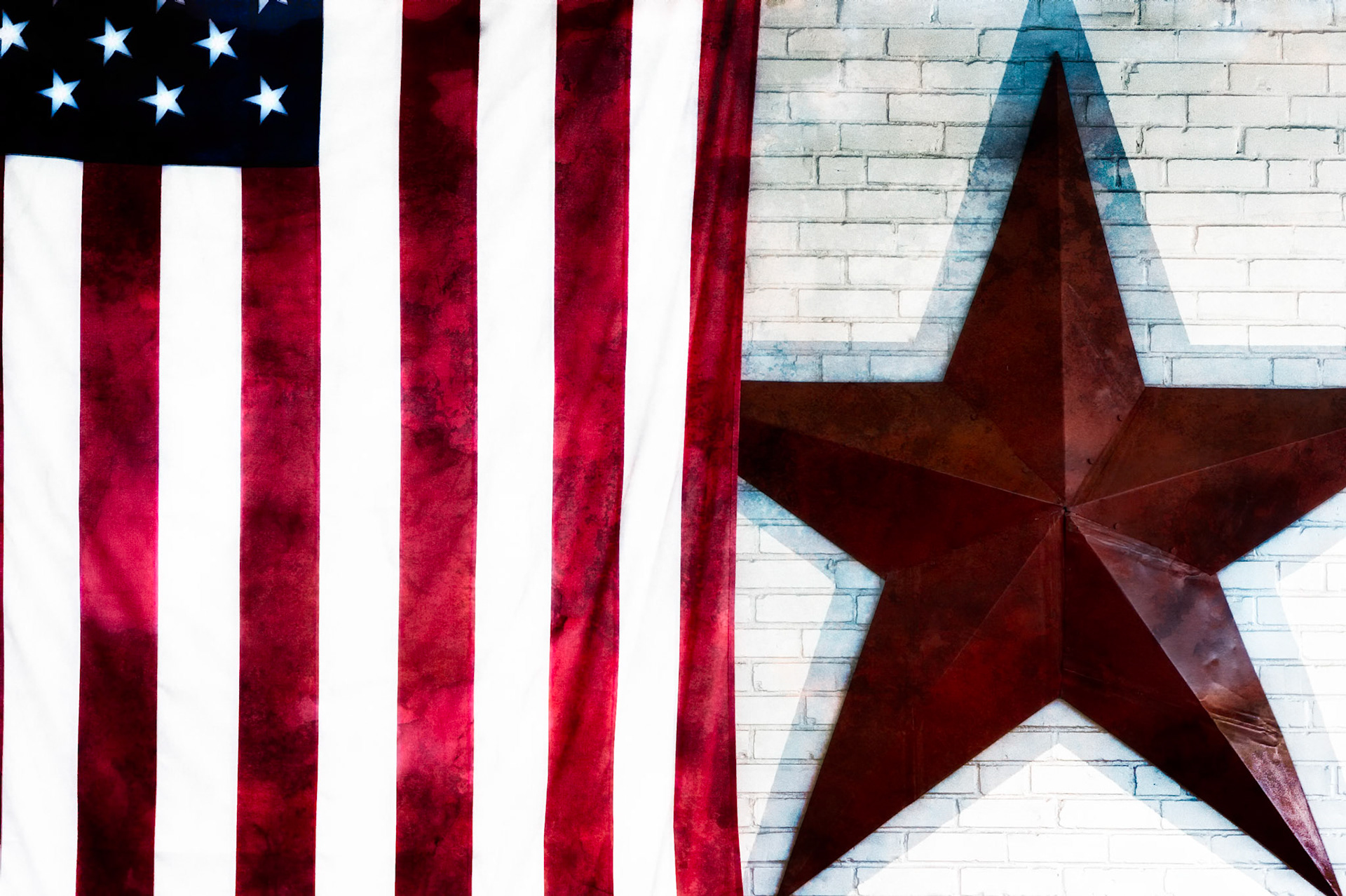A STUDY IN RED, WHITE AND BLUE  |  I came across this simple scene while wandering with my camera, drawn to the contrast between the weathered metal star and the folds of the American flag. Together they felt both familiar and timeless, symbols woven into the everyday landscape of small town America.