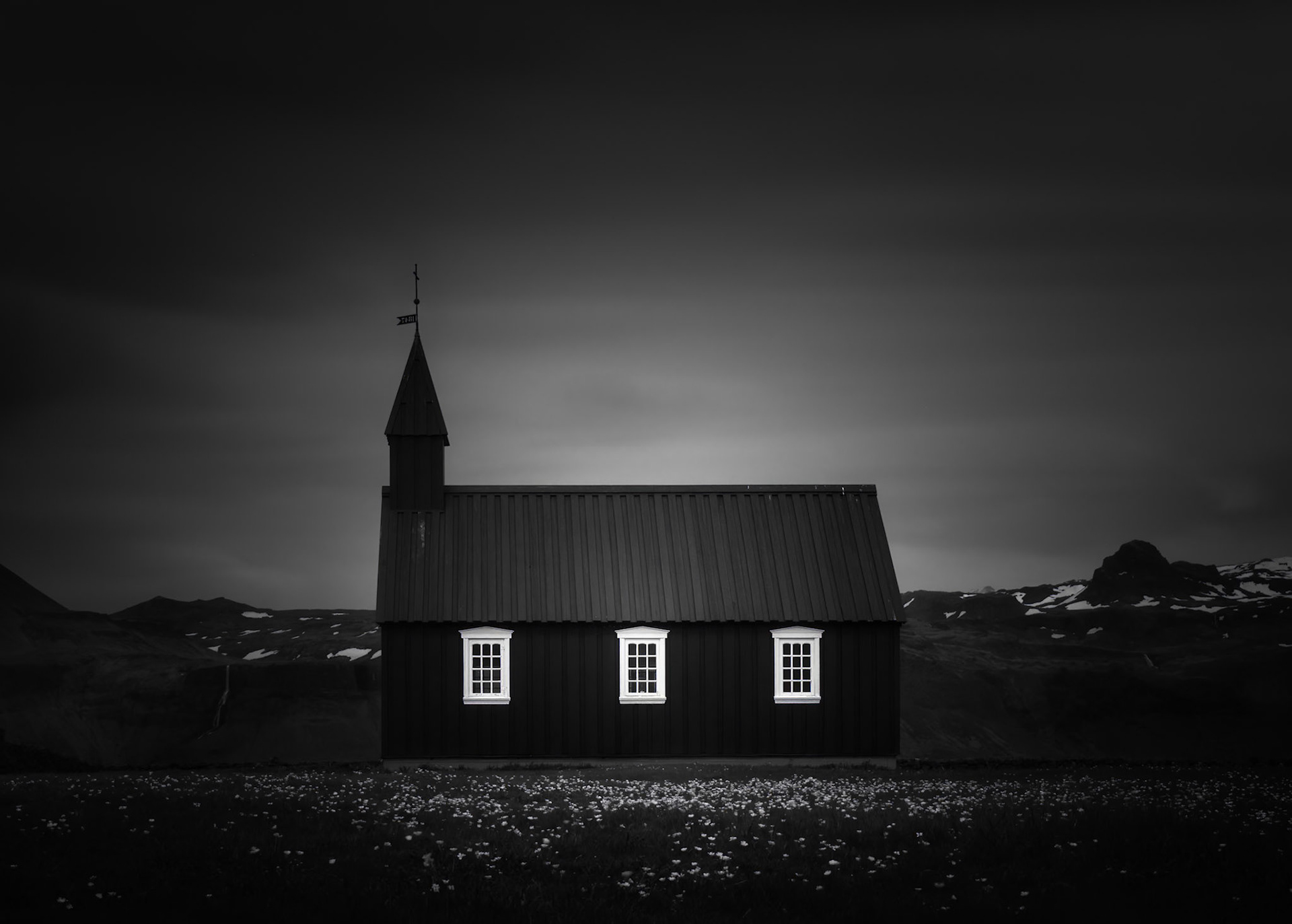 MIDNIGHT CHAPEL  |  Few buildings are as closely tied to Iceland's identity as its iconic black churches. Standing alone against a stark landscape, they embody the simplicity, resilience, and quiet strength of the people who built them.