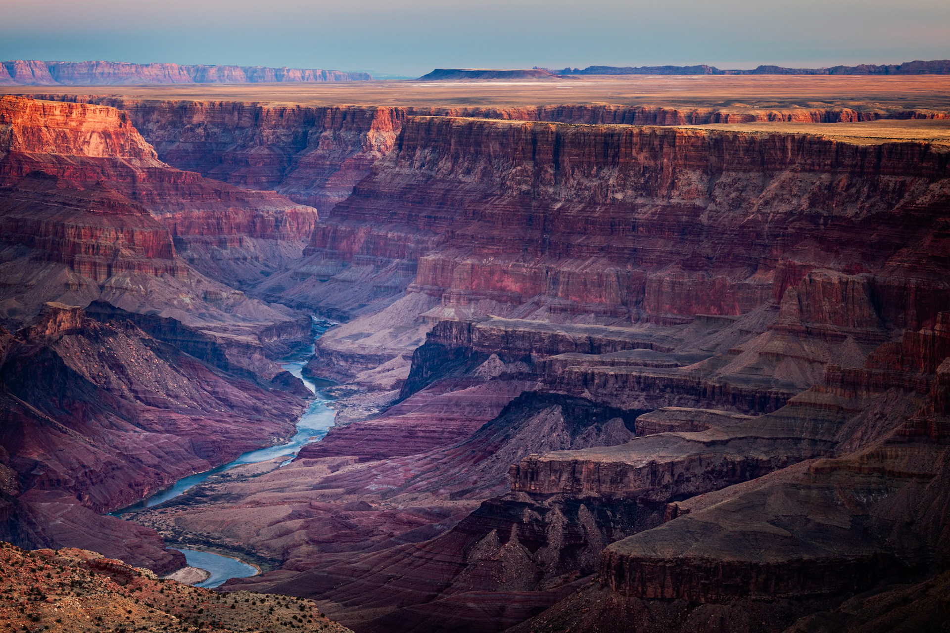 RIVER OF TIME  |  It is difficult to comprehend the Grand Canyon until you stand on its rim and follow the path of the Colorado River below.From this vantage point, the river appears almost delicate, a narrow ribbon of blue winding through an immense landscape of stone. Yet this seemingly modest waterway is the artist responsible for one of the greatest geological masterpieces on Earth. Over millions of years, it patiently carved through layer after layer of rock, revealing a history that spans nearly two billion years.What captivated me about this scene was the contrast between power and subtlety. The river does not dominate the landscape. It quietly threads its way through the canyon, almost disappearing at times. Yet every cliff, terrace, butte, and mesa owes its existence to the persistent work of moving water and time.Standing there, I was reminded that the most profound changes are often not the result of force, but persistence. The Colorado River never rushed. It simply kept flowing.