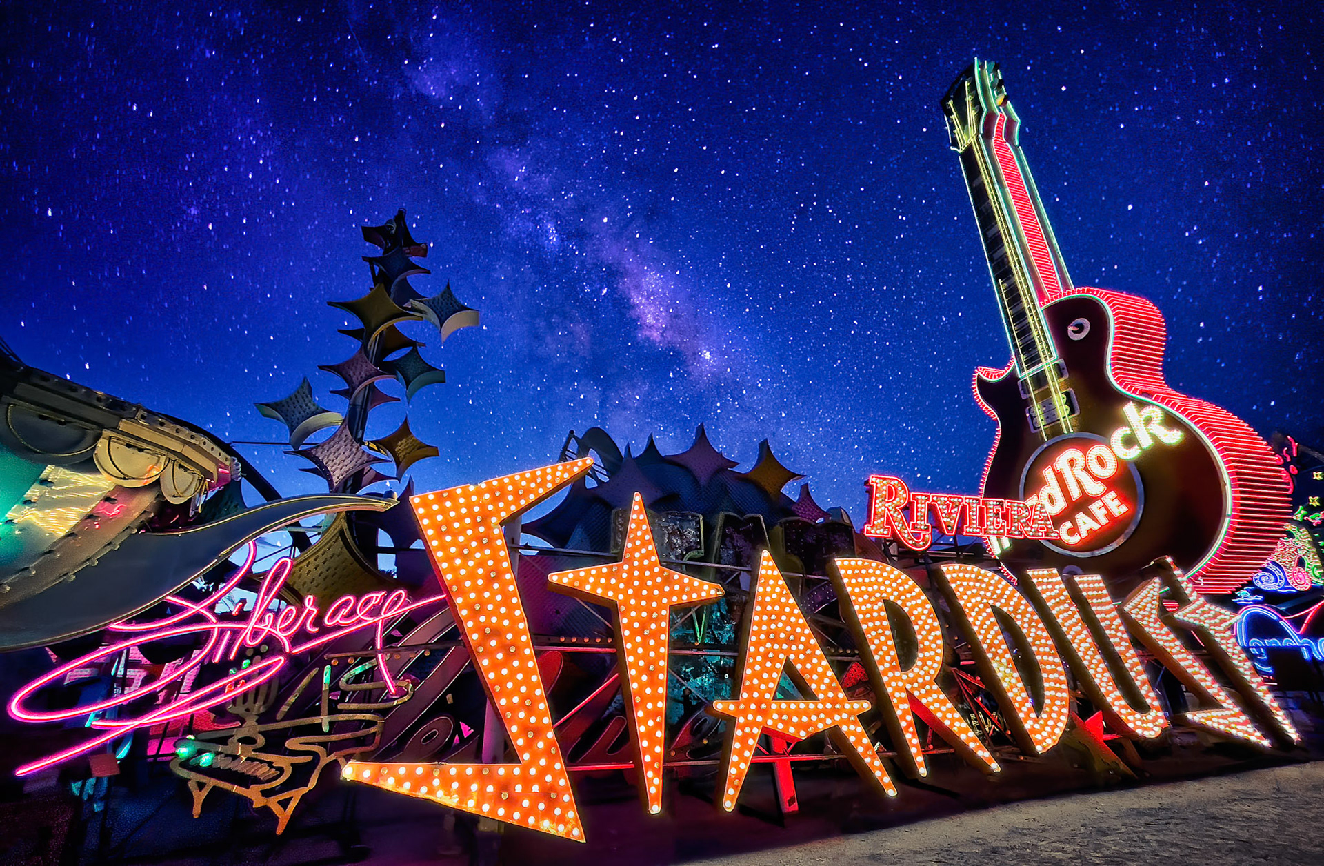 NEON STARDUST  |  Las Vegas has always reinvented itself. Hotels are demolished, casinos reimagined, and entire eras disappear almost overnight. Yet scattered among the city's constant transformation are pieces of its past that refuse to fade away.The Neon Museum preserves these icons of another time. Signs that once blazed above casinos, restaurants, and showrooms now rest together in a place where their stories can continue to be told. What might have ended in a scrapyard instead became a celebration of the city's history and imagination.On this particular night, the stars aligned in more ways than one. Beneath the glowing neon, the Milky Way stretched across the desert sky, creating an unexpected connection between human creativity and the timeless universe above. The vibrant colors and electric energy of the signs stand in contrast to the quiet permanence of the stars, reminding us that both leave their mark on history.Every sign here represents a chapter of Las Vegas. Together they form a visual archive of dreams, ambition, entertainment, and reinvention. What was once considered obsolete has become art.I am grateful that visionaries recognized the value of preserving these treasures. Without them, a remarkable part of Las Vegas history would have vanished forever.