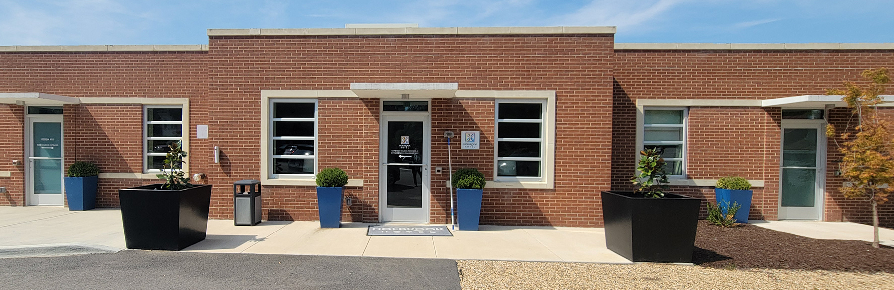 Planters Frame Doors and Add Plant Material to Paved Entrances