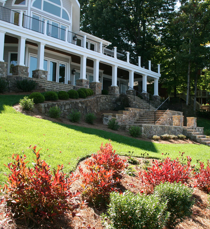 Riparian Buffer Garden of Iteas, Inkberry and Echinacea (approved by AEP) bordering Smith Mountain Lake on newly completed Water's Edge Residential Project, including: new stone terraces & stairs to creat an improved connection to boathouse and provide extensive entertaining and sitting areas.