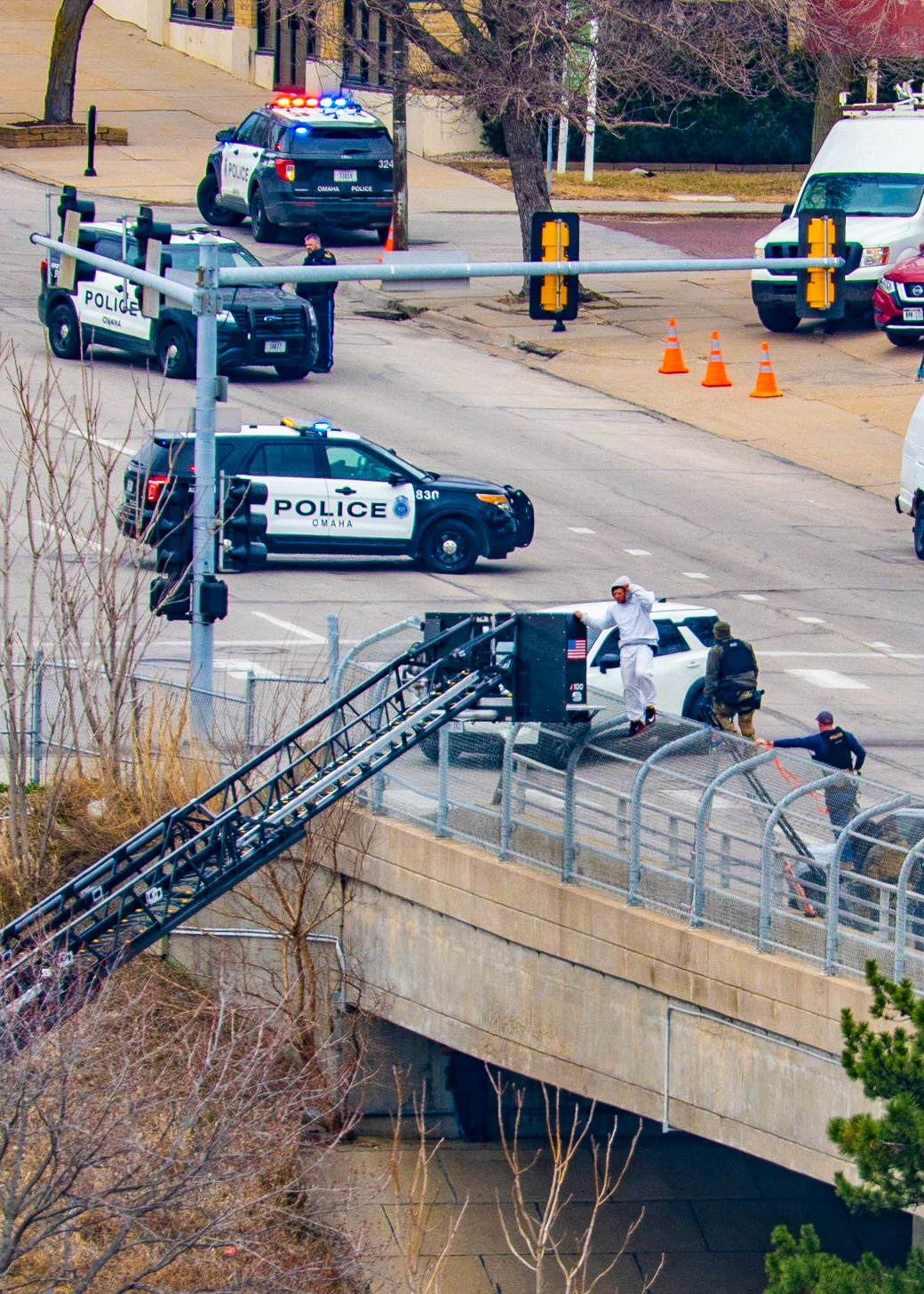 Omaha police arrested a man who climbed onto the fence of the Farnam Bridge over Interstate 480 while experiencing a mental health crisis Friday (March 31, 2023).Northbound Interstate 480 was shut down for nearly nine hours while officers assisted the man, identified as 46-year-old Frederick Patterson. (KETV 7)I spent several hours watching this drama unfold today. The situation started just before 8:00 this morning and ended just before 5:00 this evening. The Omaha Police and Fire/Rescue teams exhibited outstanding patience and professionalism in their handling of the situation.Let's hope that Mr. Patterson can find some peace, love, and understanding while obtaining professional help with his issues.