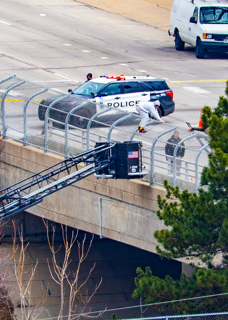 Omaha police arrested a man who climbed onto the fence of the Farnam Bridge over Interstate 480 while experiencing a mental health crisis Friday (March 31, 2023).Northbound Interstate 480 was shut down for nearly nine hours while officers assisted the man, identified as 46-year-old Frederick Patterson. (KETV 7)I spent several hours watching this drama unfold today. The situation started just before 8:00 this morning and ended just before 5:00 this evening. The Omaha Police and Fire/Rescue teams exhibited outstanding patience and professionalism in their handling of the situation.Let's hope that Mr. Patterson can find some peace, love, and understanding while obtaining professional help with his issues.