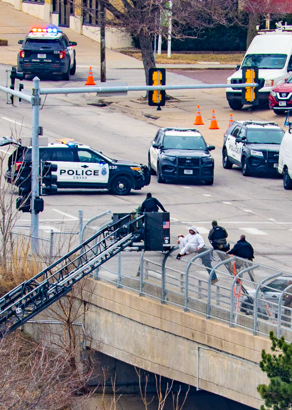 Omaha police arrested a man who climbed onto the fence of the Farnam Bridge over Interstate 480 while experiencing a mental health crisis Friday (March 31, 2023).Northbound Interstate 480 was shut down for nearly nine hours while officers assisted the man, identified as 46-year-old Frederick Patterson. (KETV 7)I spent several hours watching this drama unfold today. The situation started just before 8:00 this morning and ended just before 5:00 this evening. The Omaha Police and Fire/Rescue teams exhibited outstanding patience and professionalism in their handling of the situation.Let's hope that Mr. Patterson can find some peace, love, and understanding while obtaining professional help with his issues.