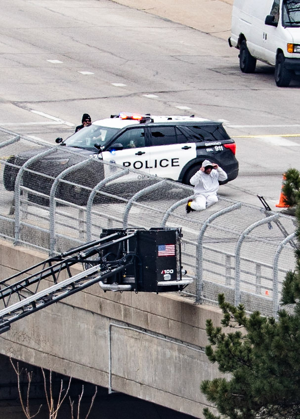 Omaha police arrested a man who climbed onto the fence of the Farnam Bridge over Interstate 480 while experiencing a mental health crisis Friday (March 31, 2023).Northbound Interstate 480 was shut down for nearly nine hours while officers assisted the man, identified as 46-year-old Frederick Patterson. (KETV 7)I spent several hours watching this drama unfold today. The situation started just before 8:00 this morning and ended just before 5:00 this evening. The Omaha Police and Fire/Rescue teams exhibited outstanding patience and professionalism in their handling of the situation.Let's hope that Mr. Patterson can find some peace, love, and understanding while obtaining professional help with his issues.
