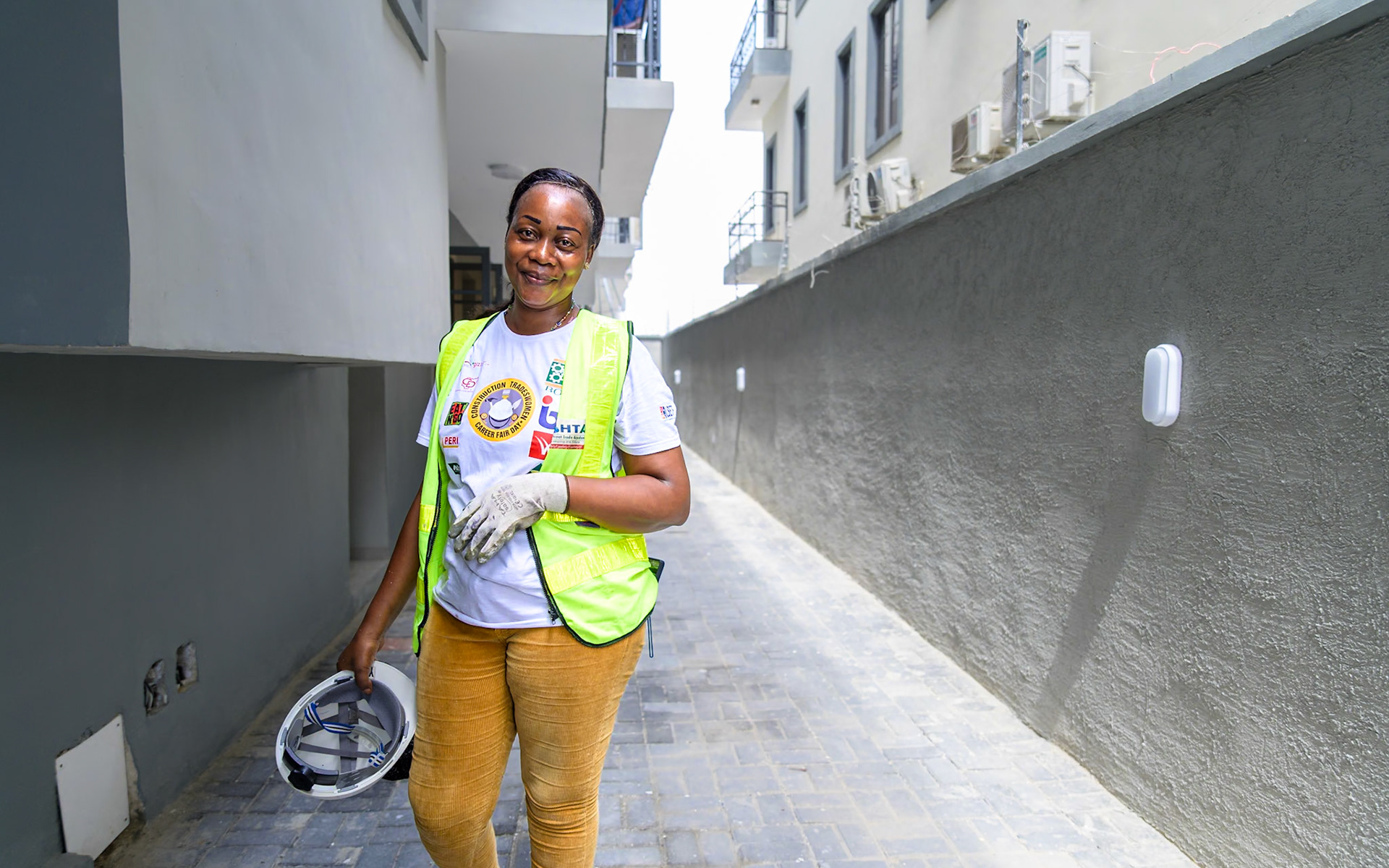Landu, a refugee woman, poses on her workplace in Lagos, Nigeria. After a professional training supervised by UNHCR, she works full time as a painter contractor and hopes to create her own company soon thanks to UNHCR's partners help and loans. Interbau Foundation in Nigeria has trained more than 2700 women in construction crafts in 2021.PoC: Refugee