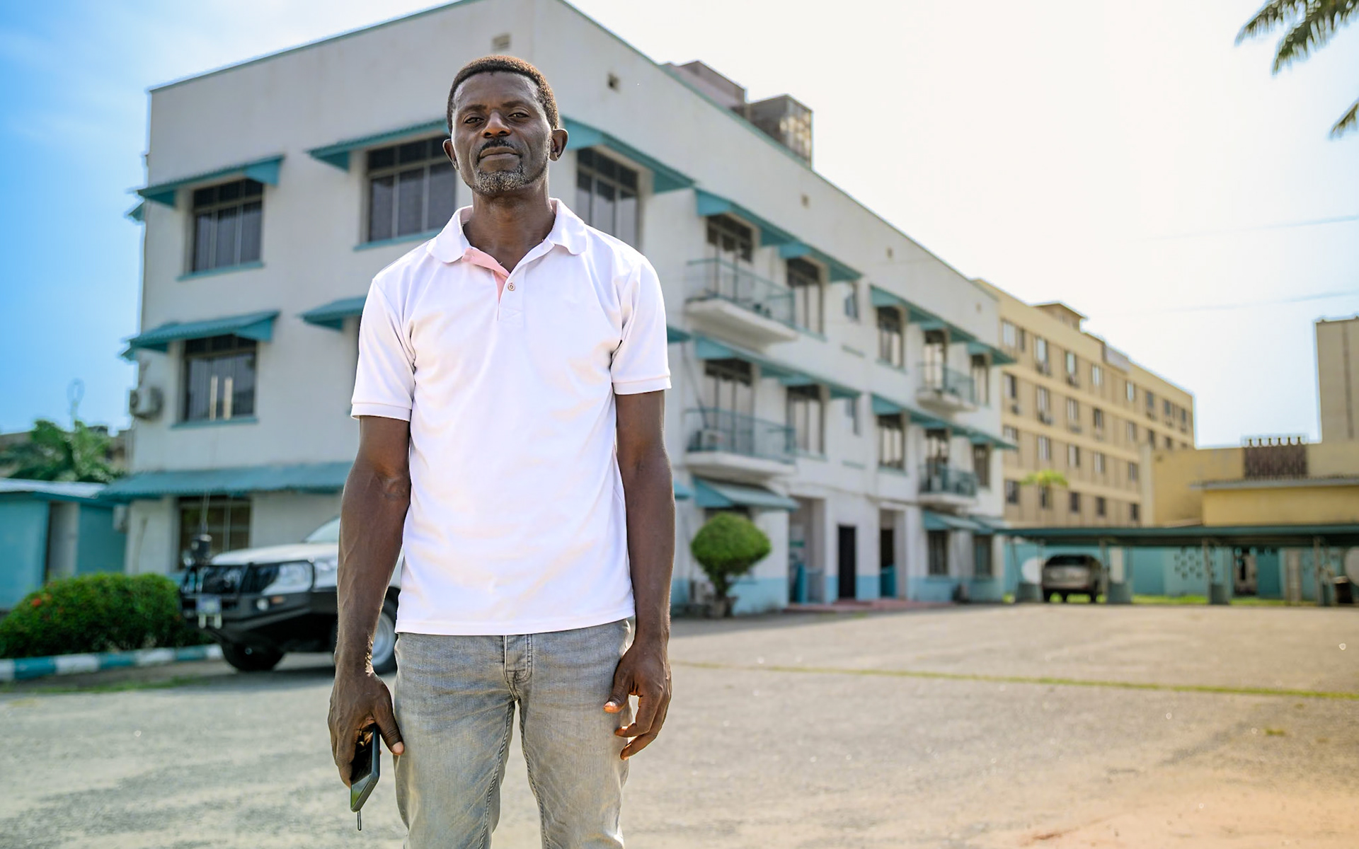 Evaristus, a refugee in Nigeria since 2019, poses in front of UNHCR office in Lagos, during a monitoring mission. After a successful carpentry training, he started an apprenticeship in a furniture workshop, carving wood and upholstering chairs. He also works on his own on the side. He would like to see more people taking up these trainings, and "give hope to people who lost hope".PoC: Refugee