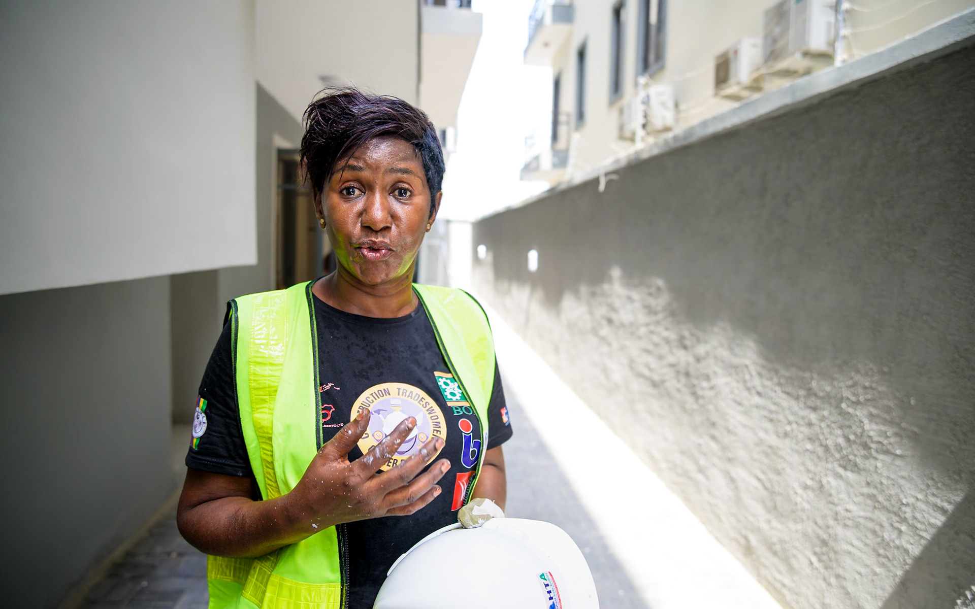 Mpela Leontin Ndonda, a refugee woman, poses on her workplace in Lagos, Nigeria. After a professional training supervised by UNHCR, she works full time as a painter contractor and hopes to create her own company soon thanks to UNHCR's partners help and loans. Interbau Foundation in Nigeria has trained more than 2700 women in construction crafts in 2021.PoC: Refugee