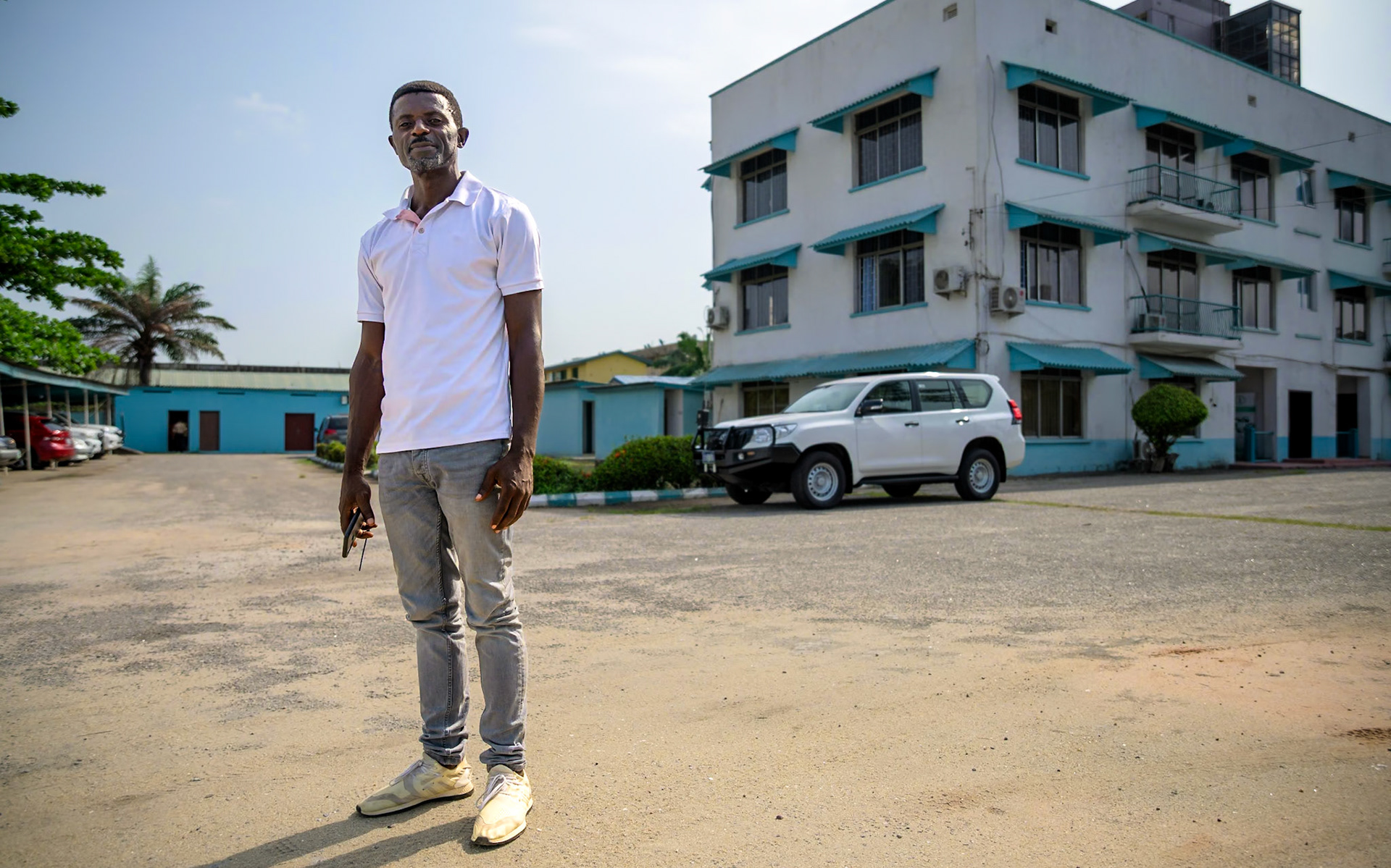 Evaristus, a refugee in Nigeria since 2019, poses in front of UNHCR office in Lagos, during a monitoring mission. After a successful carpentry training, he started an apprenticeship in a furniture workshop, carving wood and upholstering chairs. He also works on his own on the side. He would like to see more people taking up these trainings, and "give hope to people who lost hope".PoC: Refugee