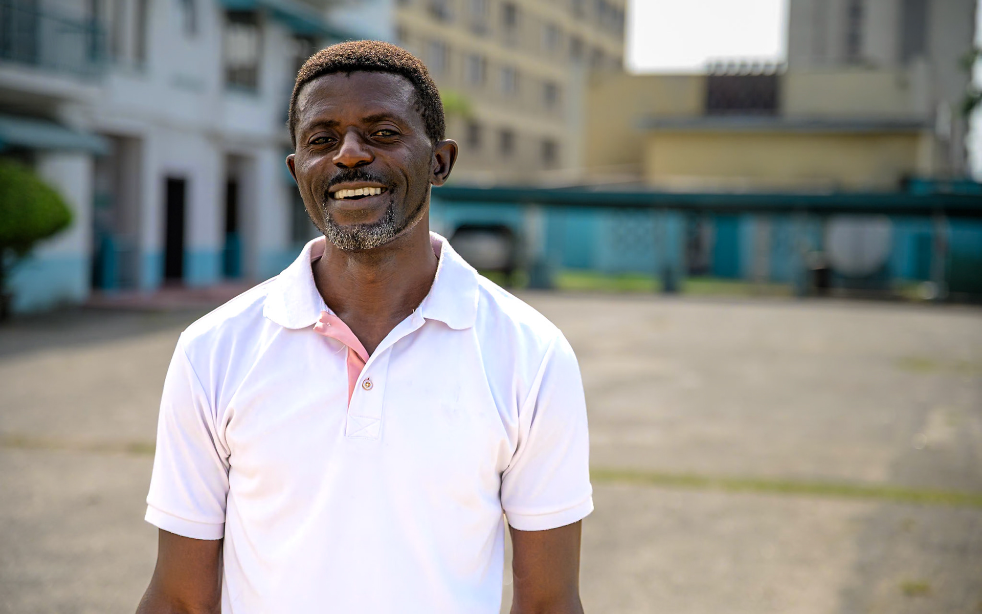 Evaristus, a refugee in Nigeria since 2019, poses in front of UNHCR office in Lagos, during a monitoring mission. After a successful carpentry training, he started an apprenticeship in a furniture workshop, carving wood and upholstering chairs. He also works on his own on the side. He would like to see more people taking up these trainings, and "give hope to people who lost hope".PoC: Refugee