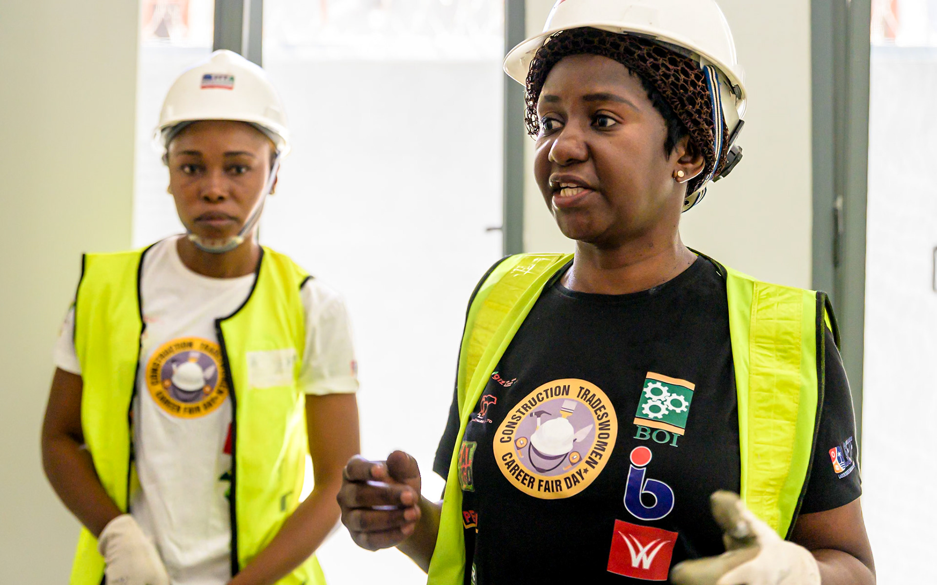 Three women refugees pose on their workplace in Lagos, Nigeria. After a professional training supervised by UNHCR, they work full time as painters, through a national tradewomen's association. They hope to have their own company soon thanks to UNHCR's partners help and loans. Interbau Foundation in Nigeria has trained more than 2700 women in construction crafts in 2021.PoC: Refugee