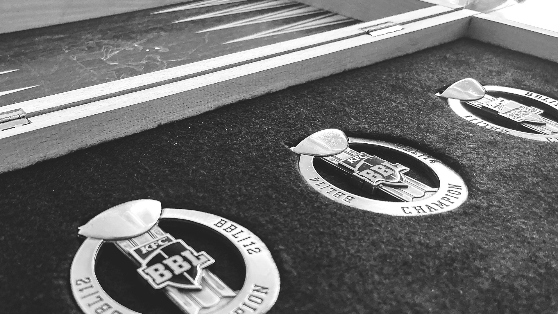 Process image showing medals inset into black felt for Peter Hatzoglou commemorative artwork