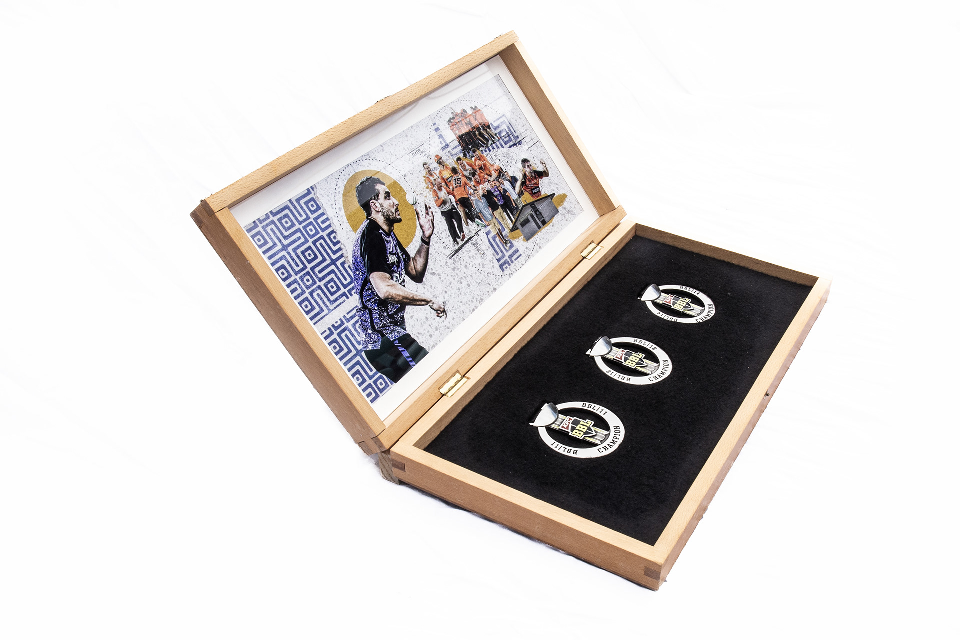 Detail of Peter Hatzoglou commemoration showing three Big Bash medals set into black felt inside the backgammon case