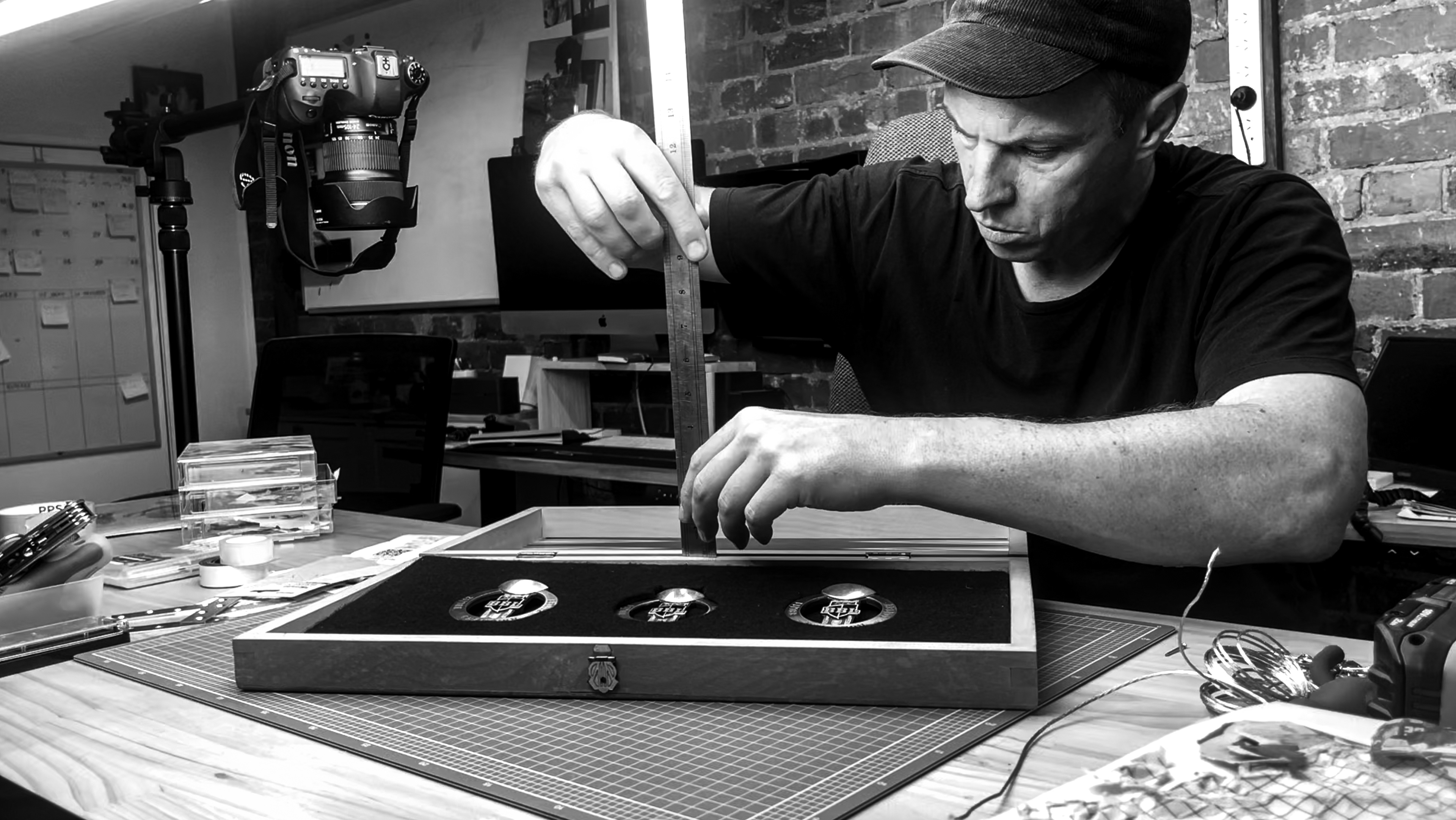 Process image of Sports Artist Dan Toomey setting Big Bash League medals into backgammon board