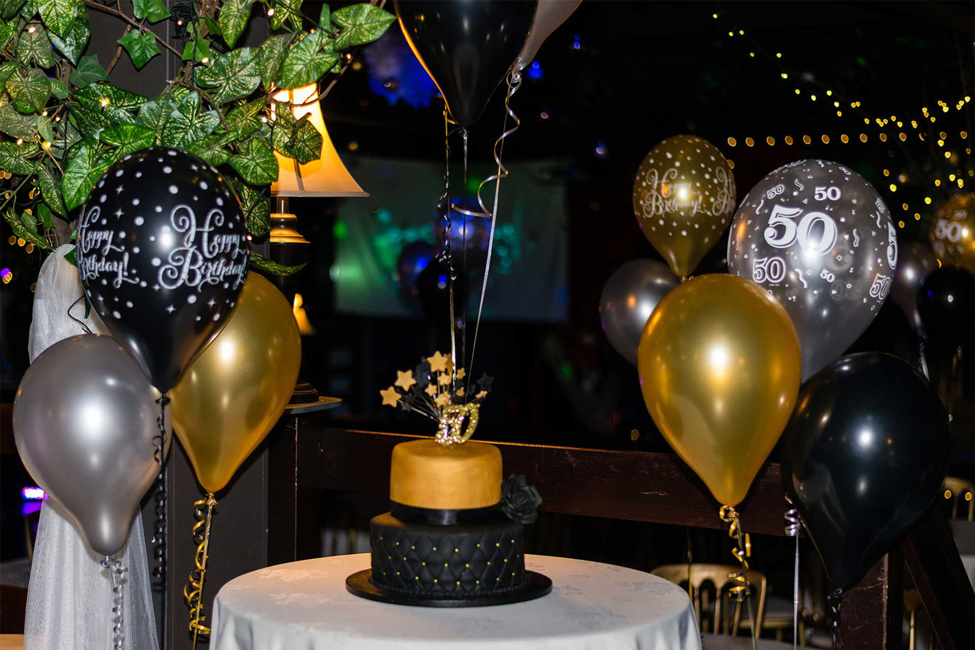 50th birthday cake and balloons