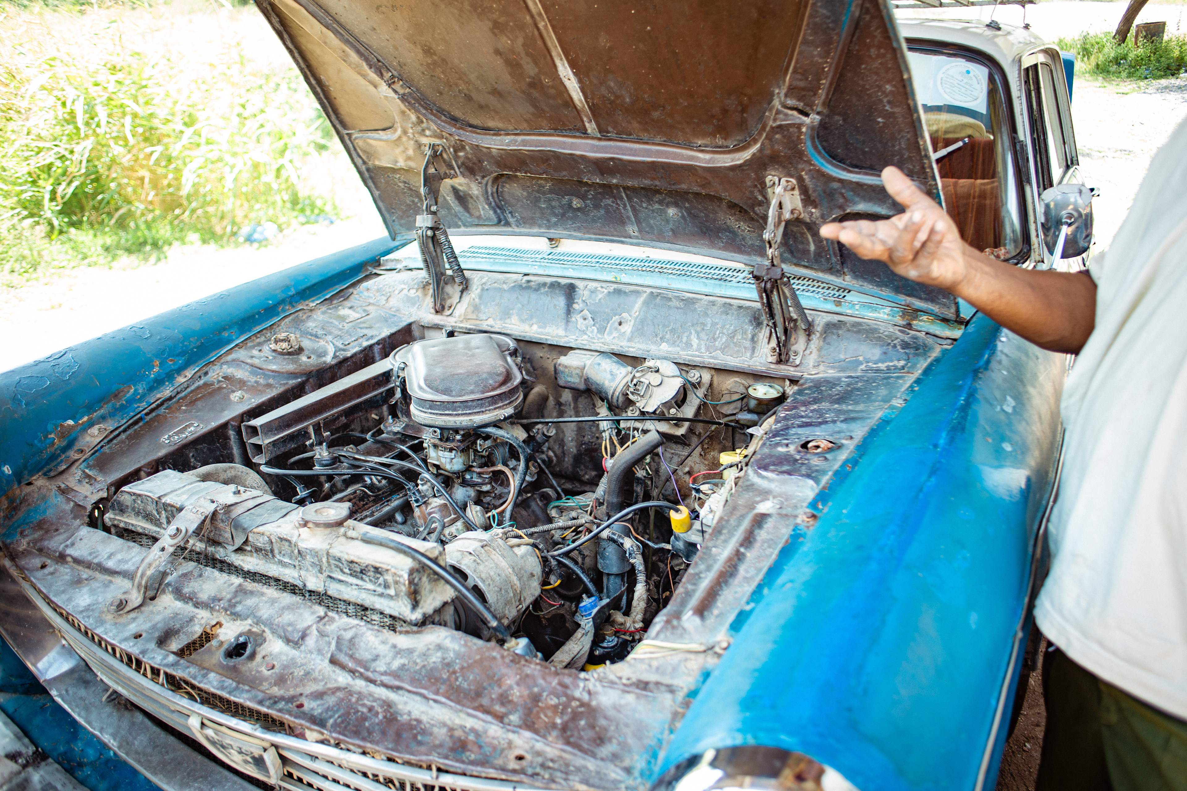  Alemu Yama looks under the hood of his Peugeot 404. “A car never dies with quality,” he says.