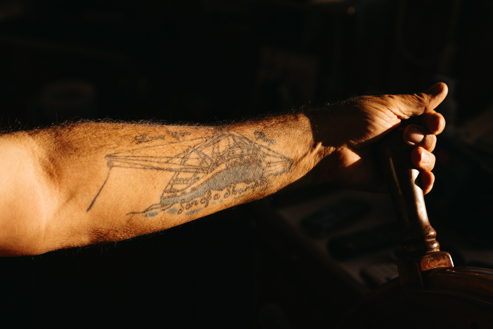 Captain Jimmy's tattoo which reads "Son of a Shrimp"
