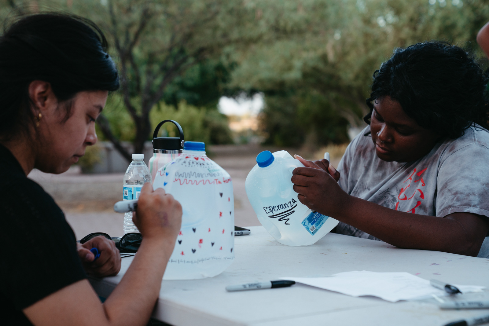 Decorating gallon jugs the night before the water drop.