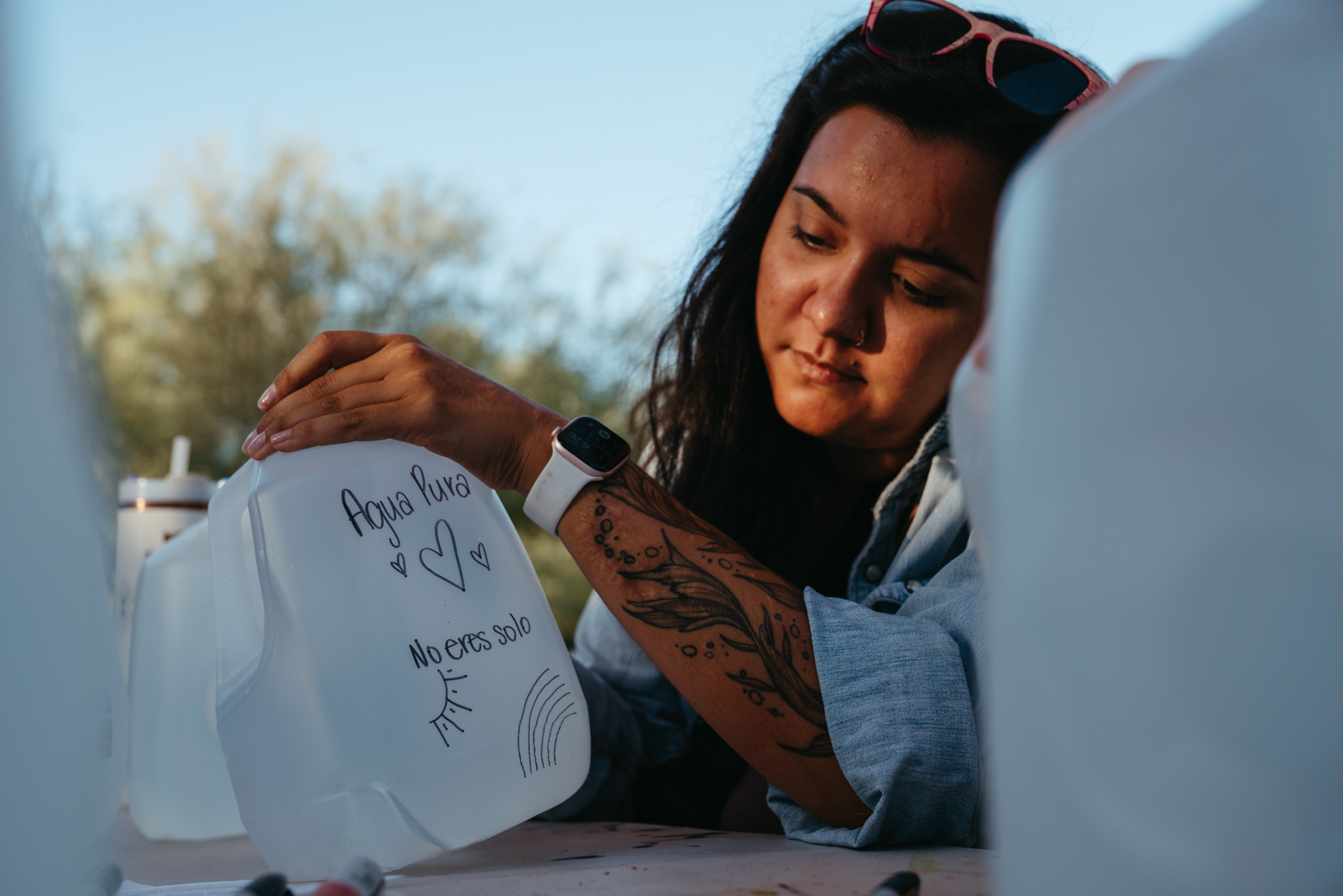 The night before the water drop, volunteers added designs to water jugs at Las Milpitas Community Farm