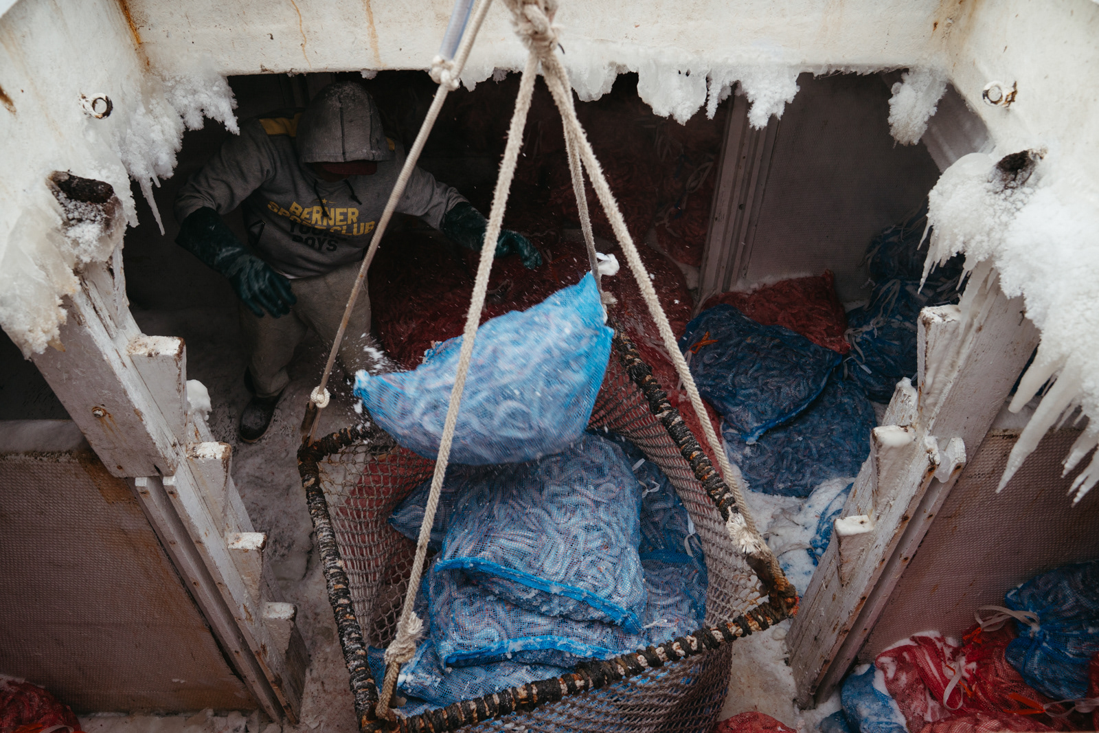 Valentine loads bags of frozen shrimp on the Night Hawk