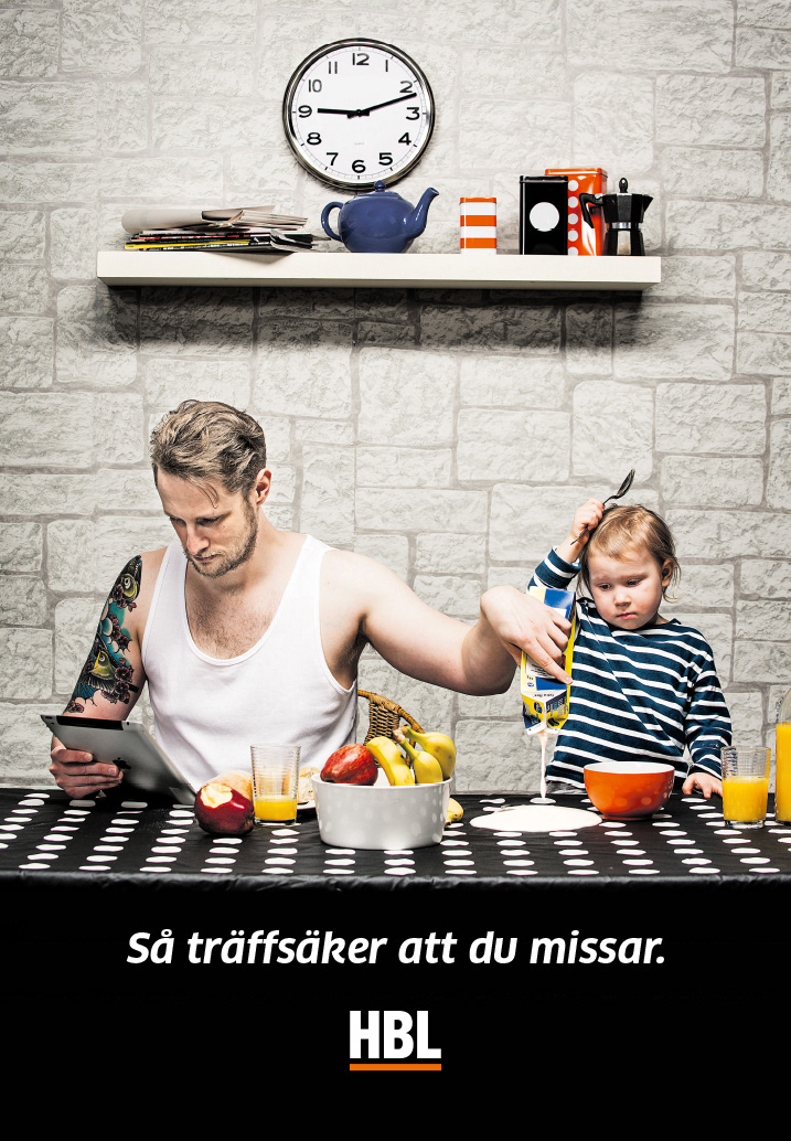newsprint ad with distracted dad pouring yoghurt on the table while young child is looking confused