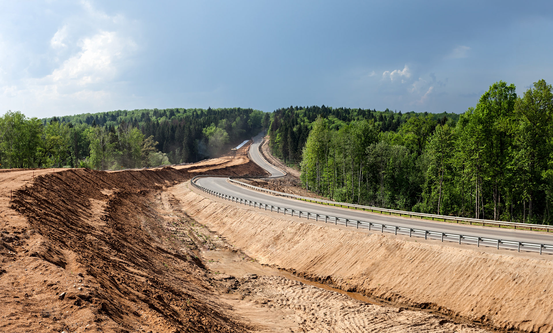 Construction of the embankment for exit from highway among the forest in Russia
