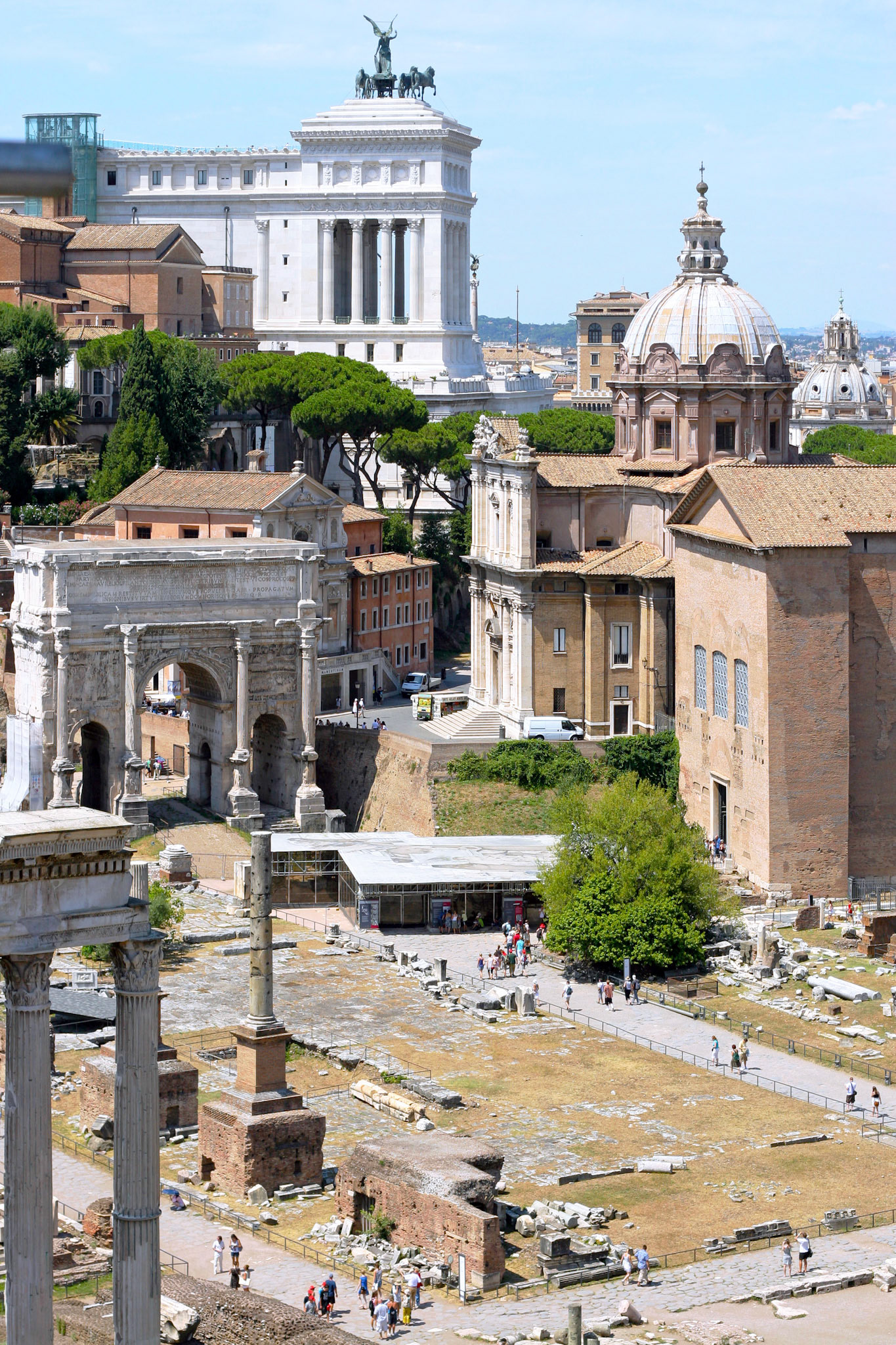 ROME - AUGUST 4:  Ruins of the Roman Forum, church Santi Luca e Martina and Vittoriano on August 4, 2010 in Rome. There are three roman epochs at once on this photograph.