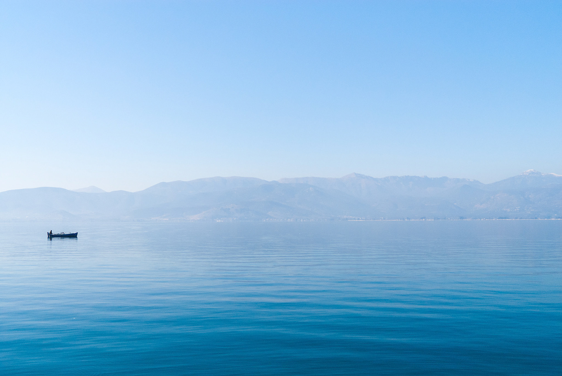 Lonely fisher in the sea near Nafplio, Greece