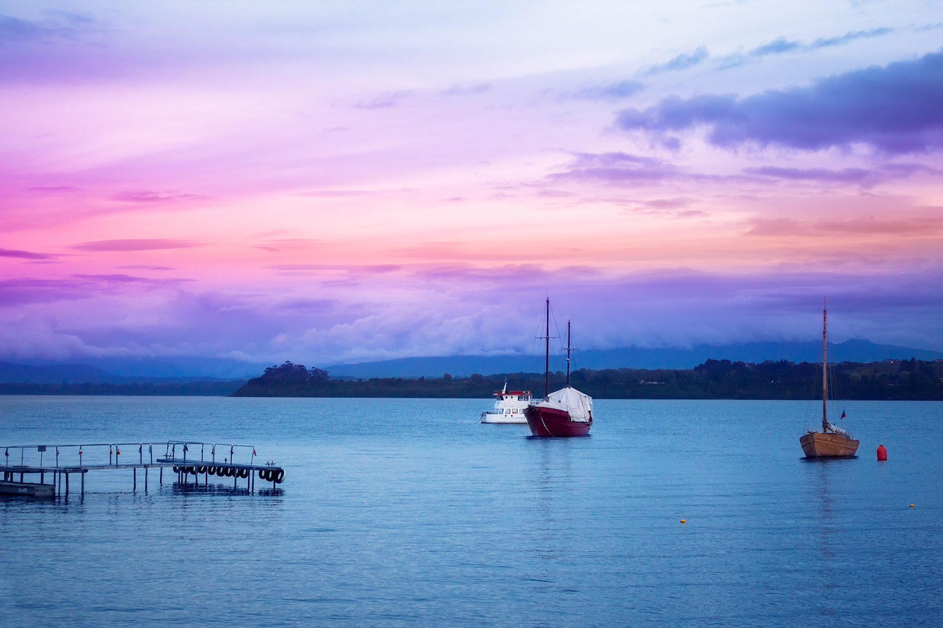 Evening lake Llanquihue with boats and coastline in the distance