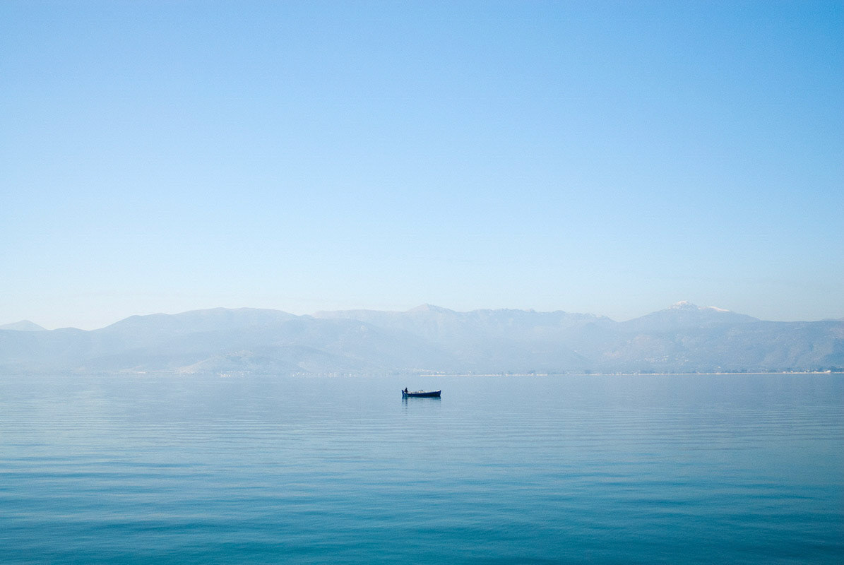 Lonely fisher in the sea near Nafplio, Greece