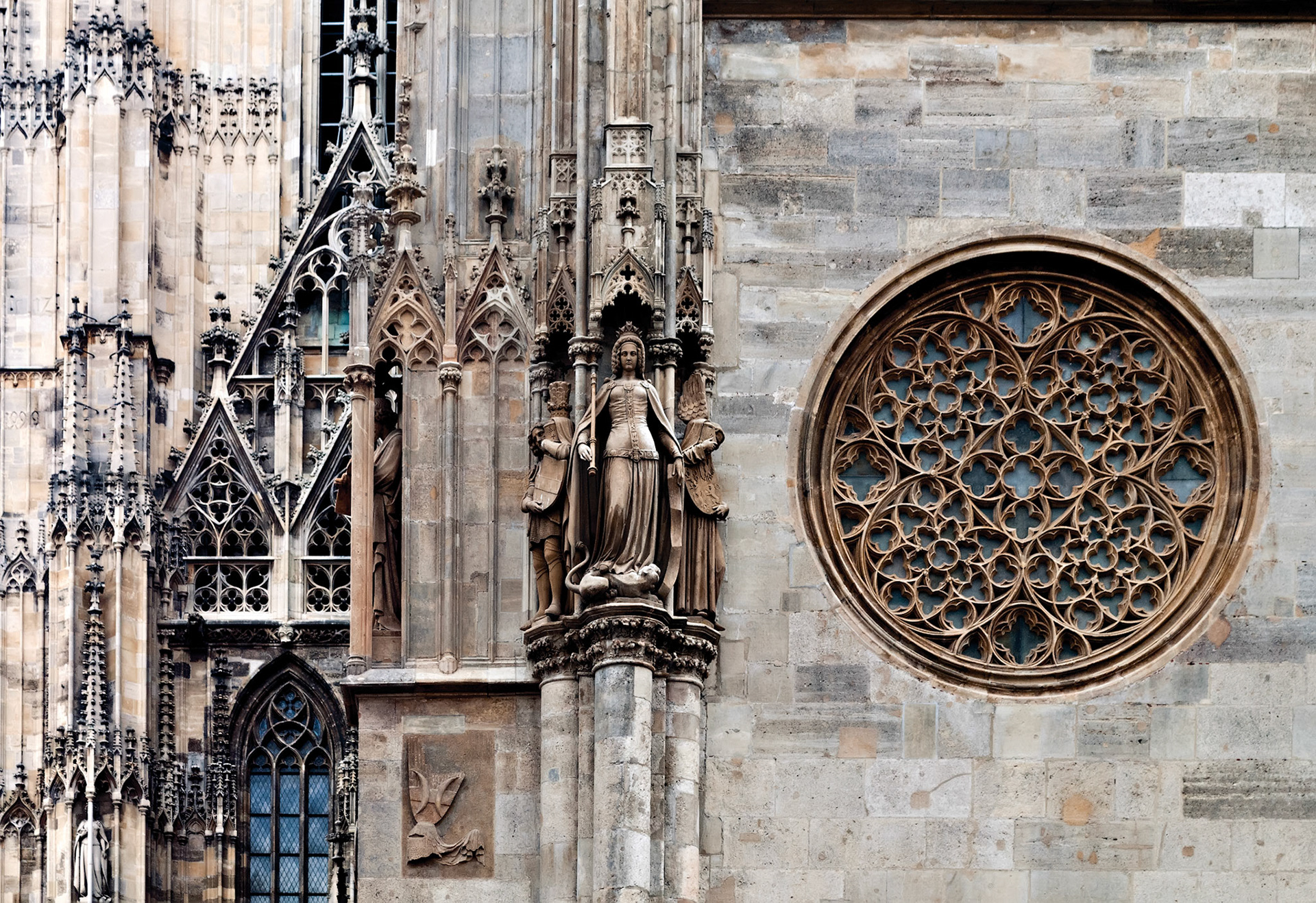 Rose window, maiden statue and other details of the famous cathedral of saint Stephan, Vienna, Austria