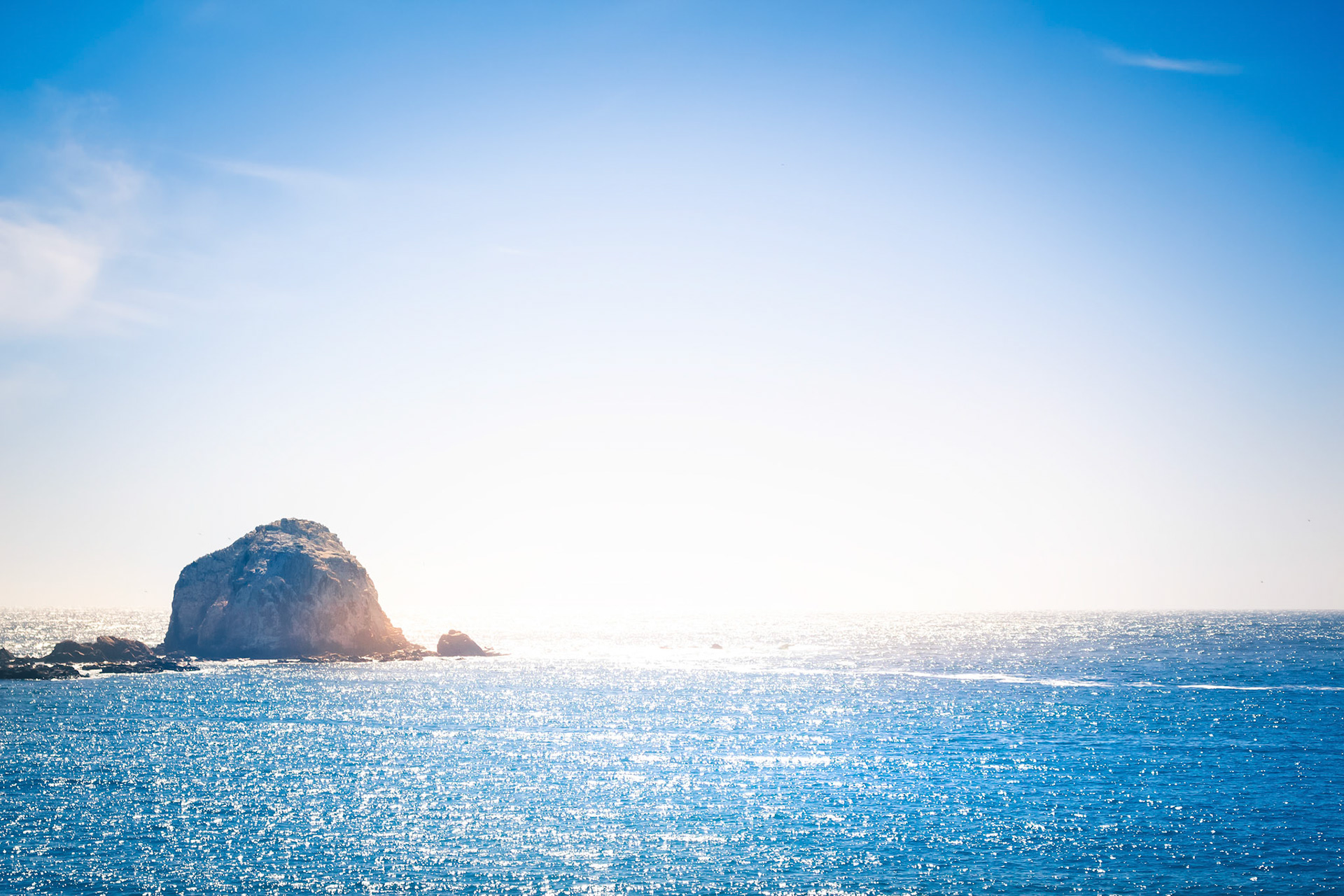 View of the pacific ocean and rocky island on a horison in Chile