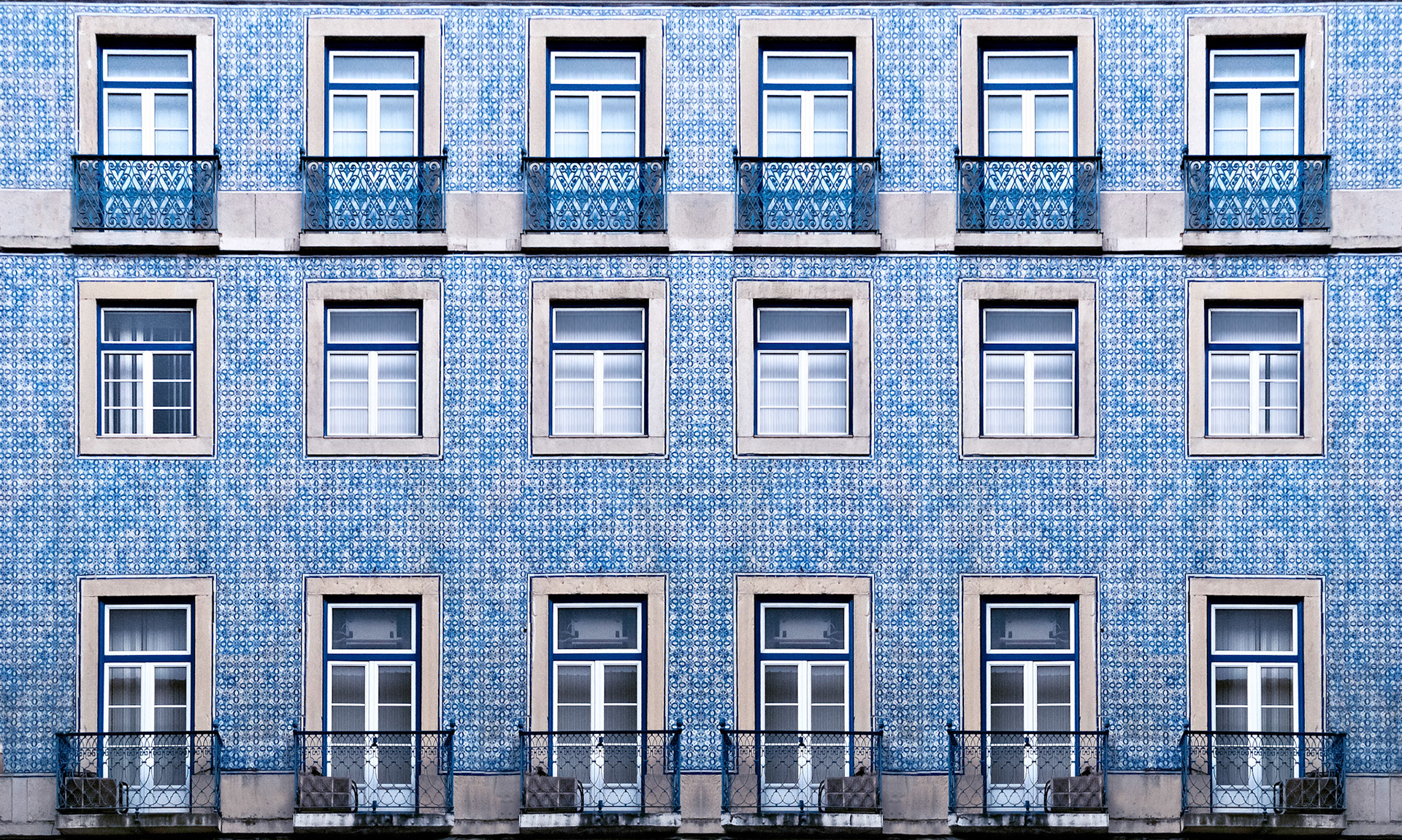 Lisbon windows with typical portuguese tiles on the wall