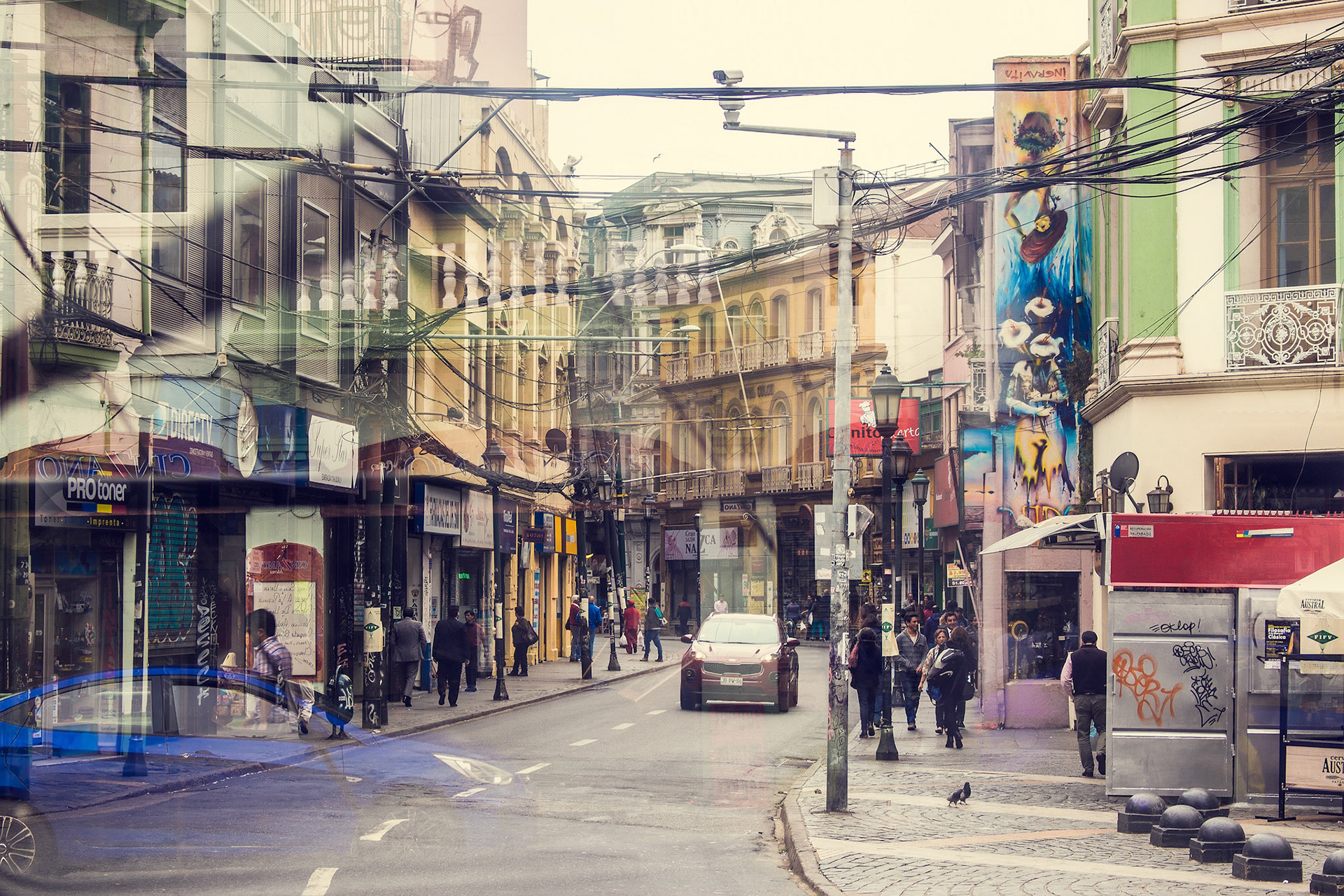 VALPARAISO, CHILE - OCTOBER 27, 2016: View of Valparaiso street taken from bus with reflections on the glass. Valparaiso is very picturesque city and famous as a UNESCO World Heritage Site.
