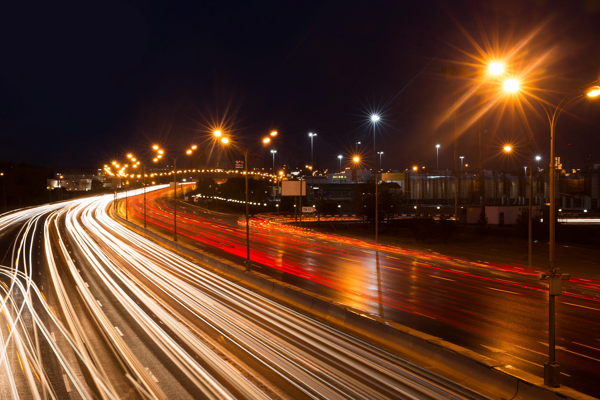Illuminated highway at night with light trails